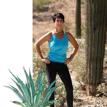 Christine Anderson standing beside an agave drawing in the Arizona desert