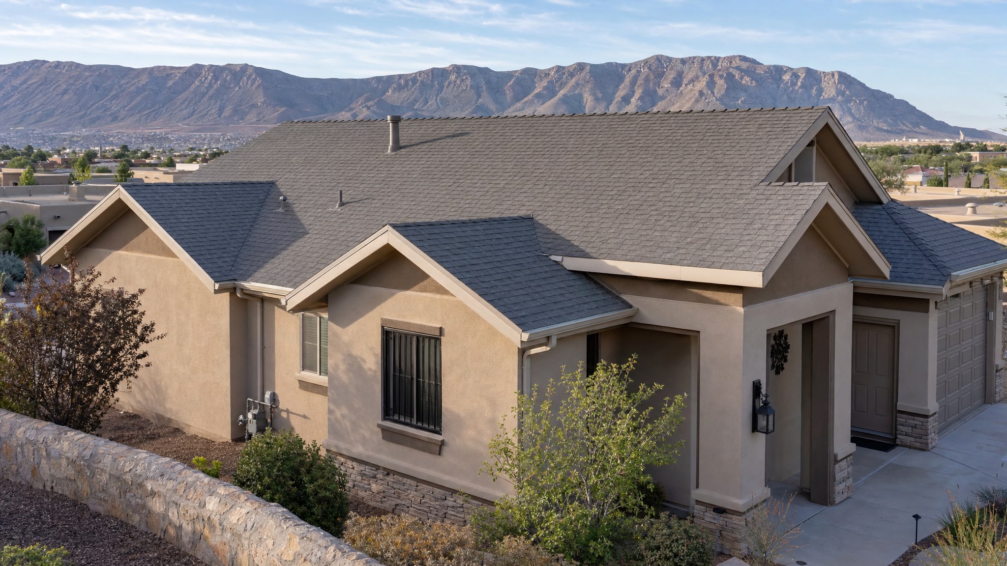 Well-maintained shingle roof on an El Paso home with Franklin Mountains in the background