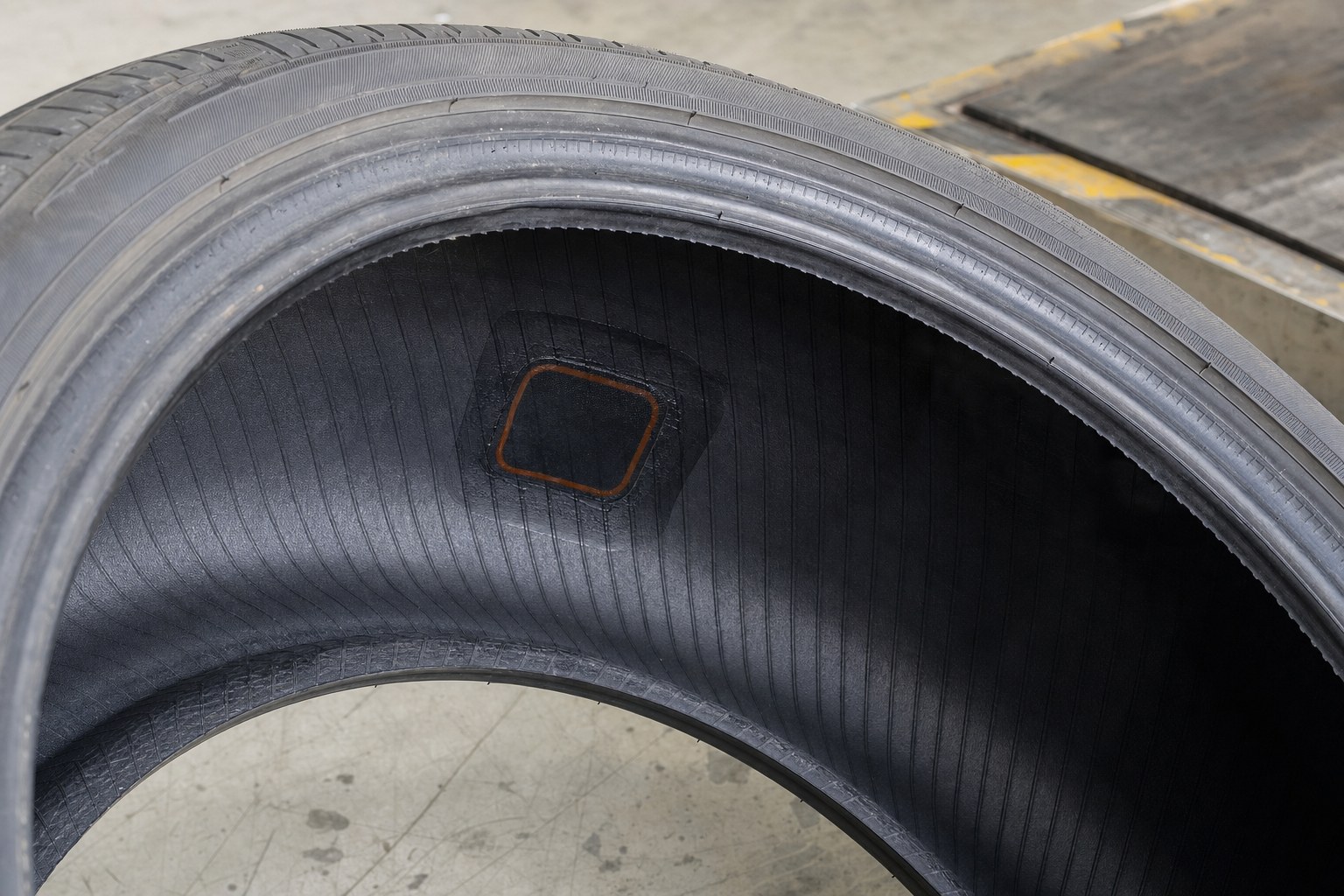 Inside view of a removed tire showing an internal puncture-repair inspection area