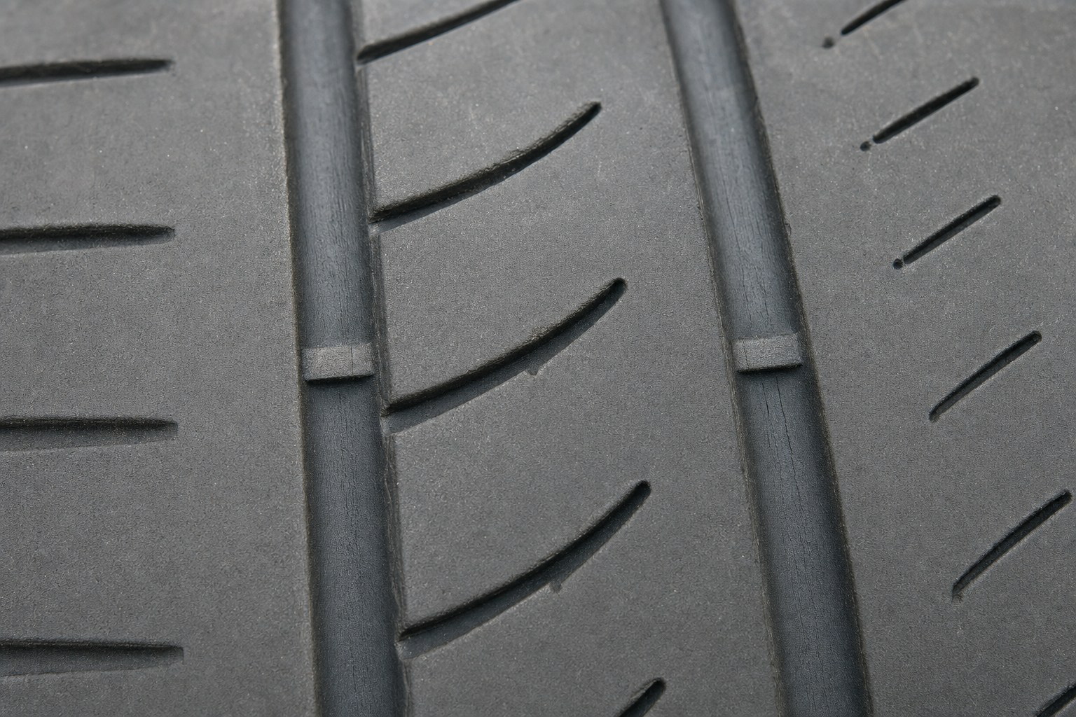 Close-up view of treadwear indicator bars in tire grooves