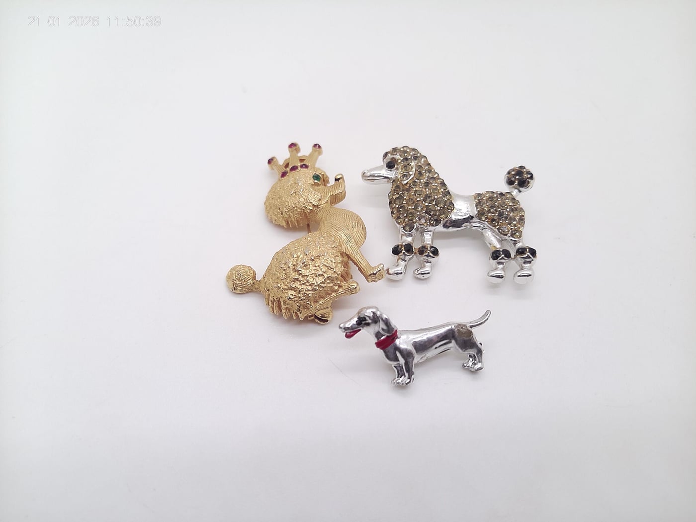 Vintage Poodle brooches and a Weiner Dog.