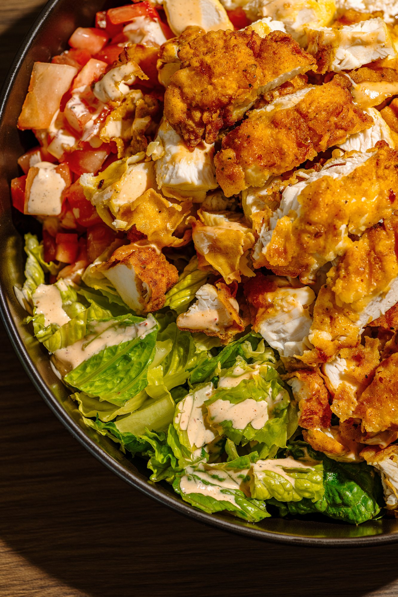 A Tito’s chicken bowl with rice, beans, lettuce, and sauce