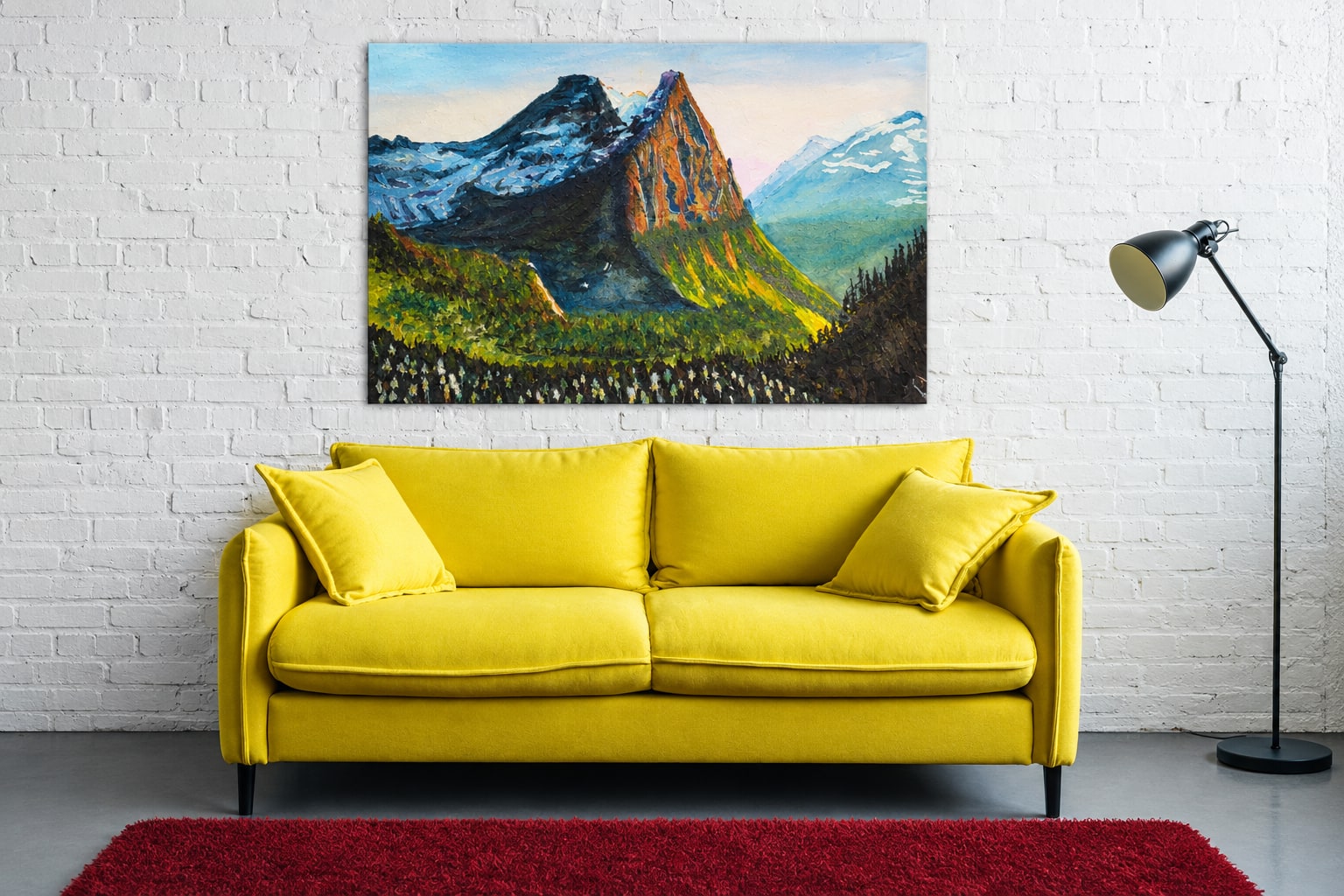 Mountain landscape artwork above a bold yellow sofa