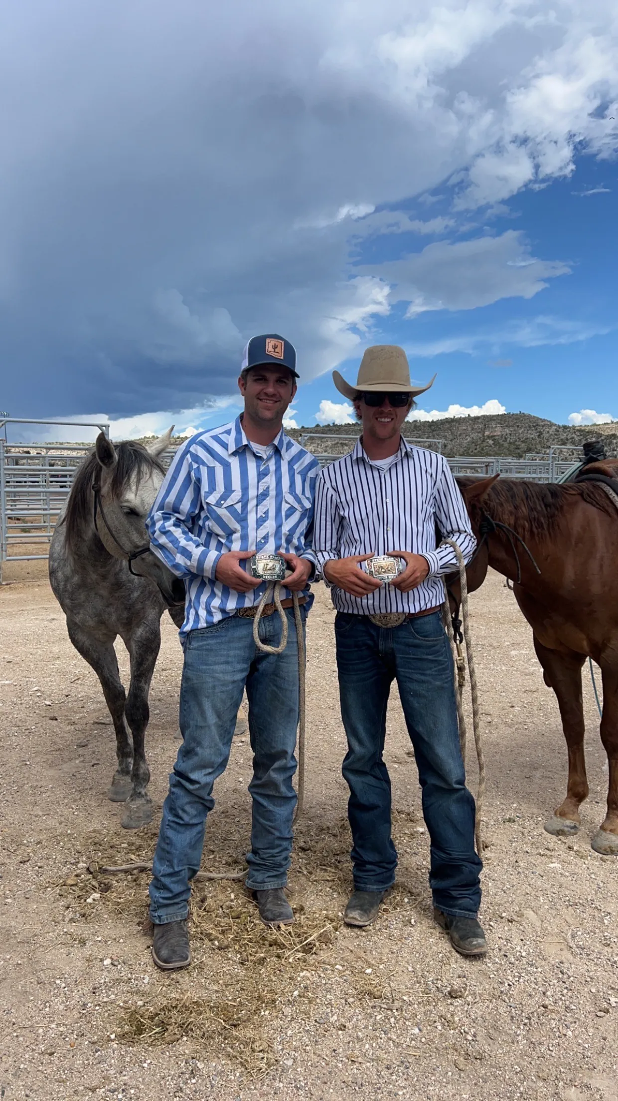 Two people standing with horses at Bar W Performance Horses