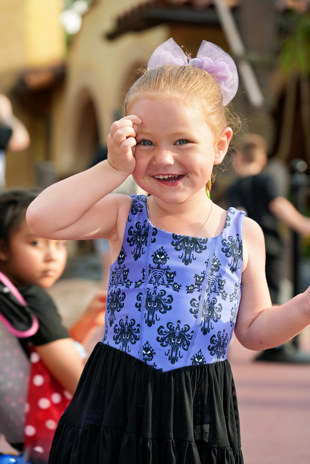 Londyn smiling in her purple printed dress with a lilac bow