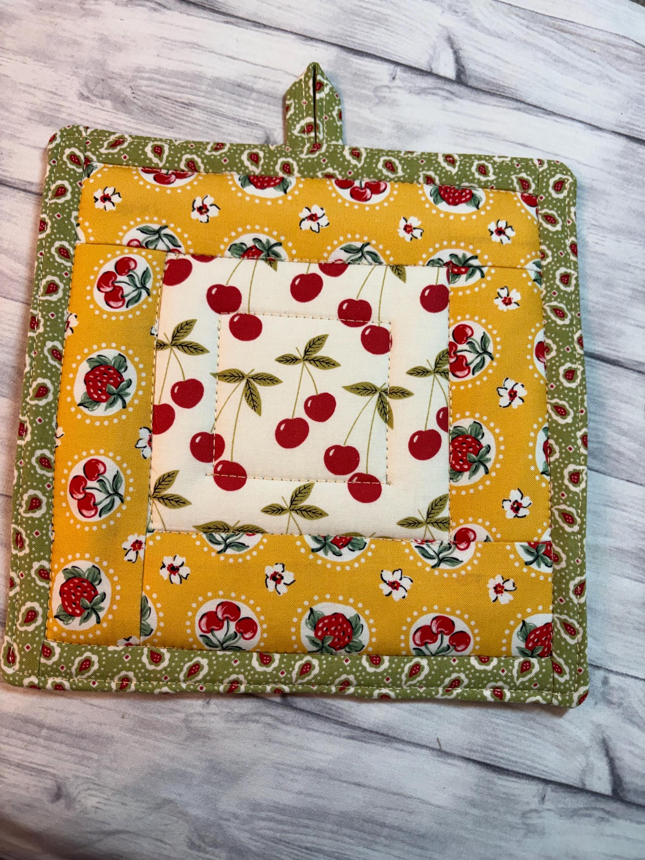 Single vintage cherry fabric potholder, 8.25” homemade quilted