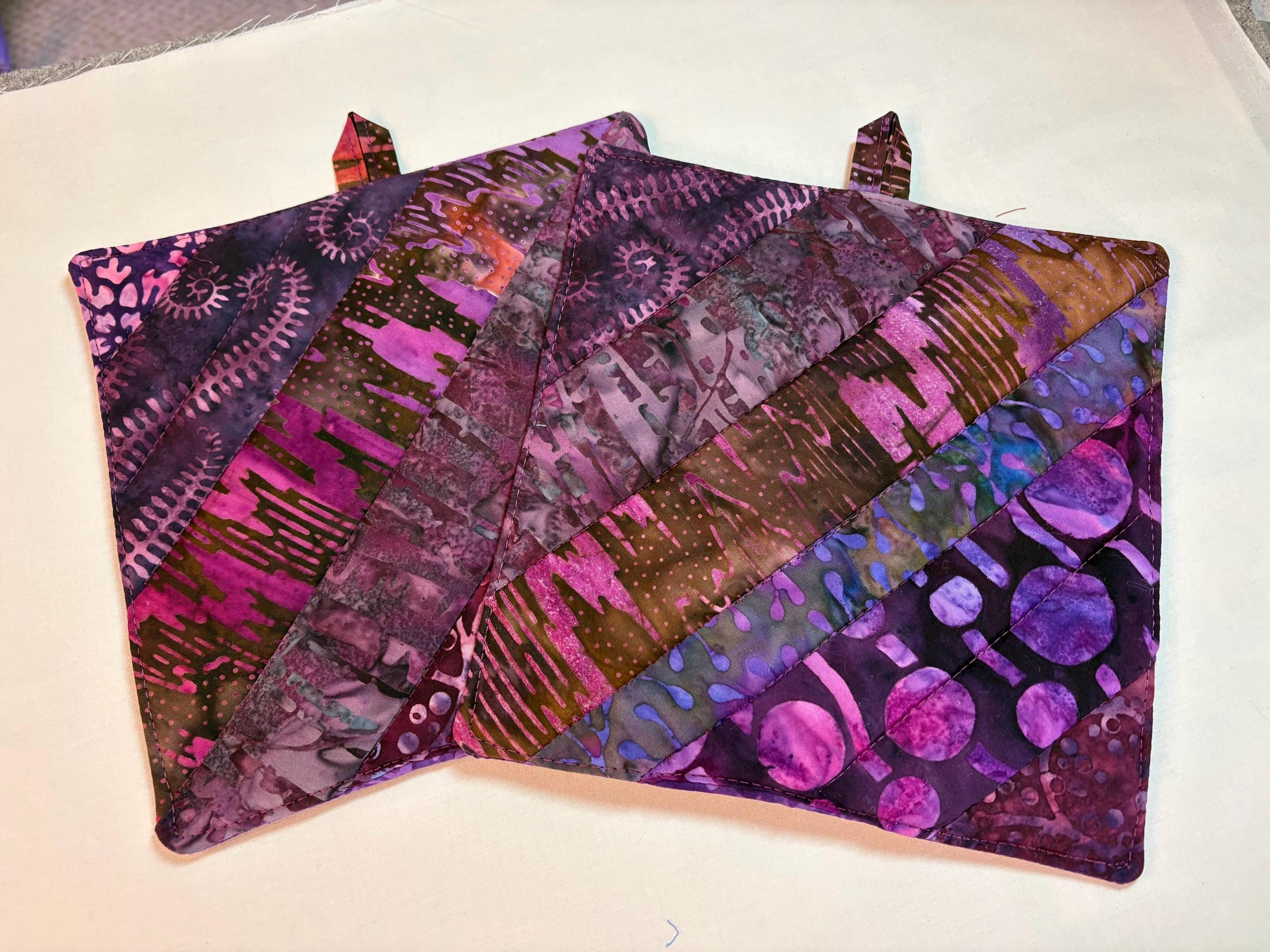 Pair of Scrappy purple Batik potholders, 8” homemade quilted