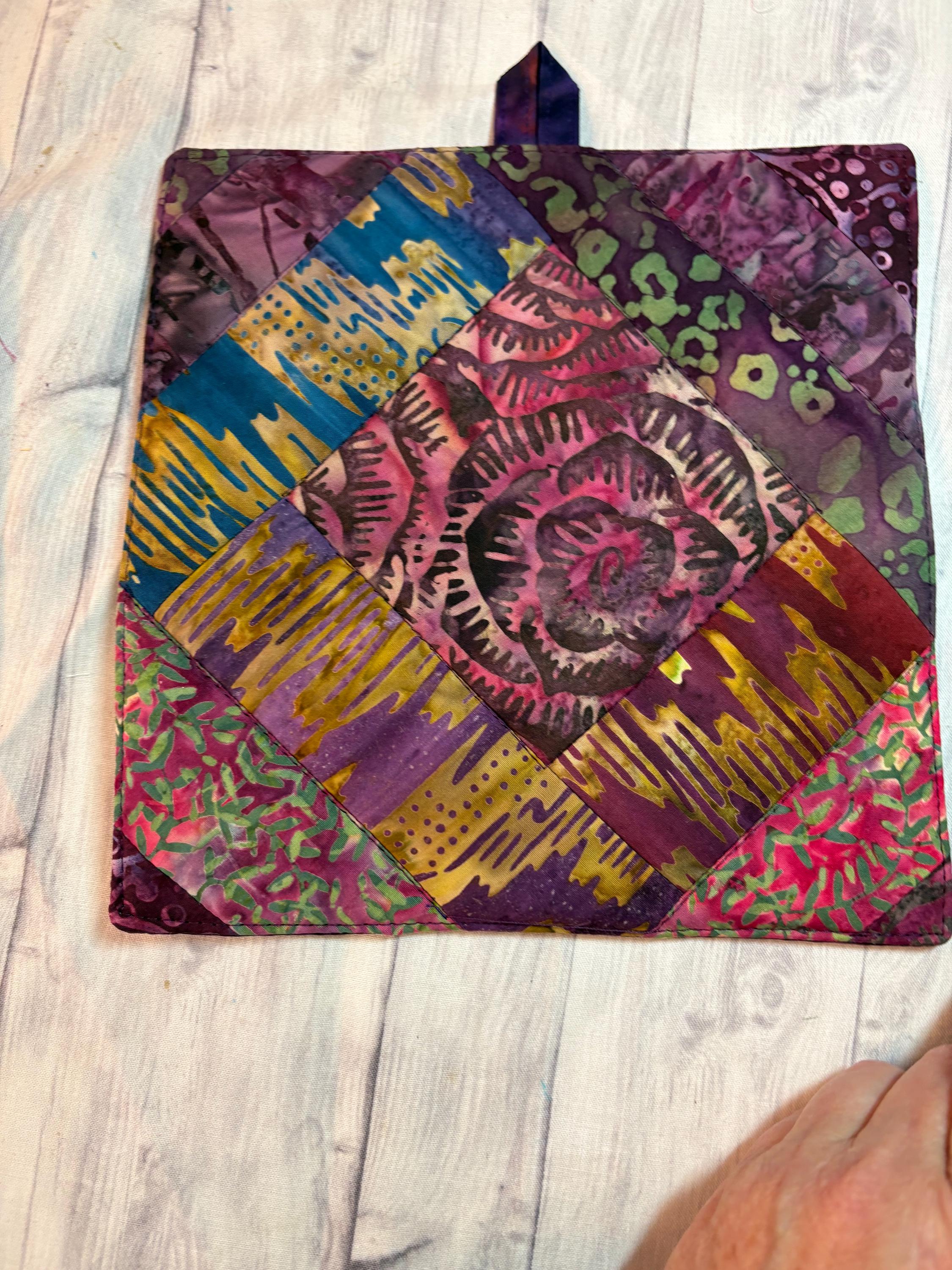 Pair of Scrappy purple Batik potholders rose center, 8” homemade quilted