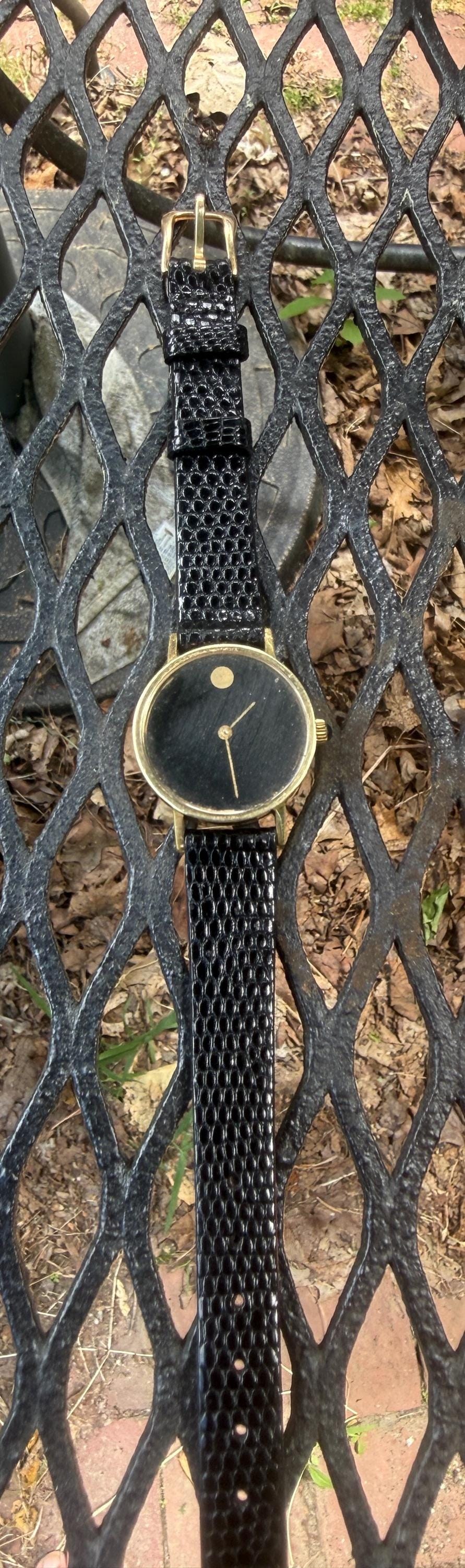 Movado by Zenith manual wind woman’s Museum 14K gold watch including buckleand crown with sapphire setting
