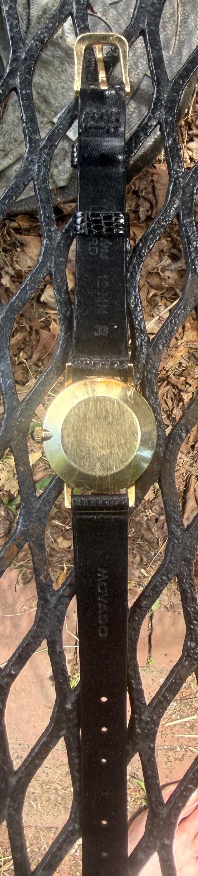 Movado by Zenith manual wind woman’s Museum 14K gold watch including buckleand crown with sapphire setting detail 10