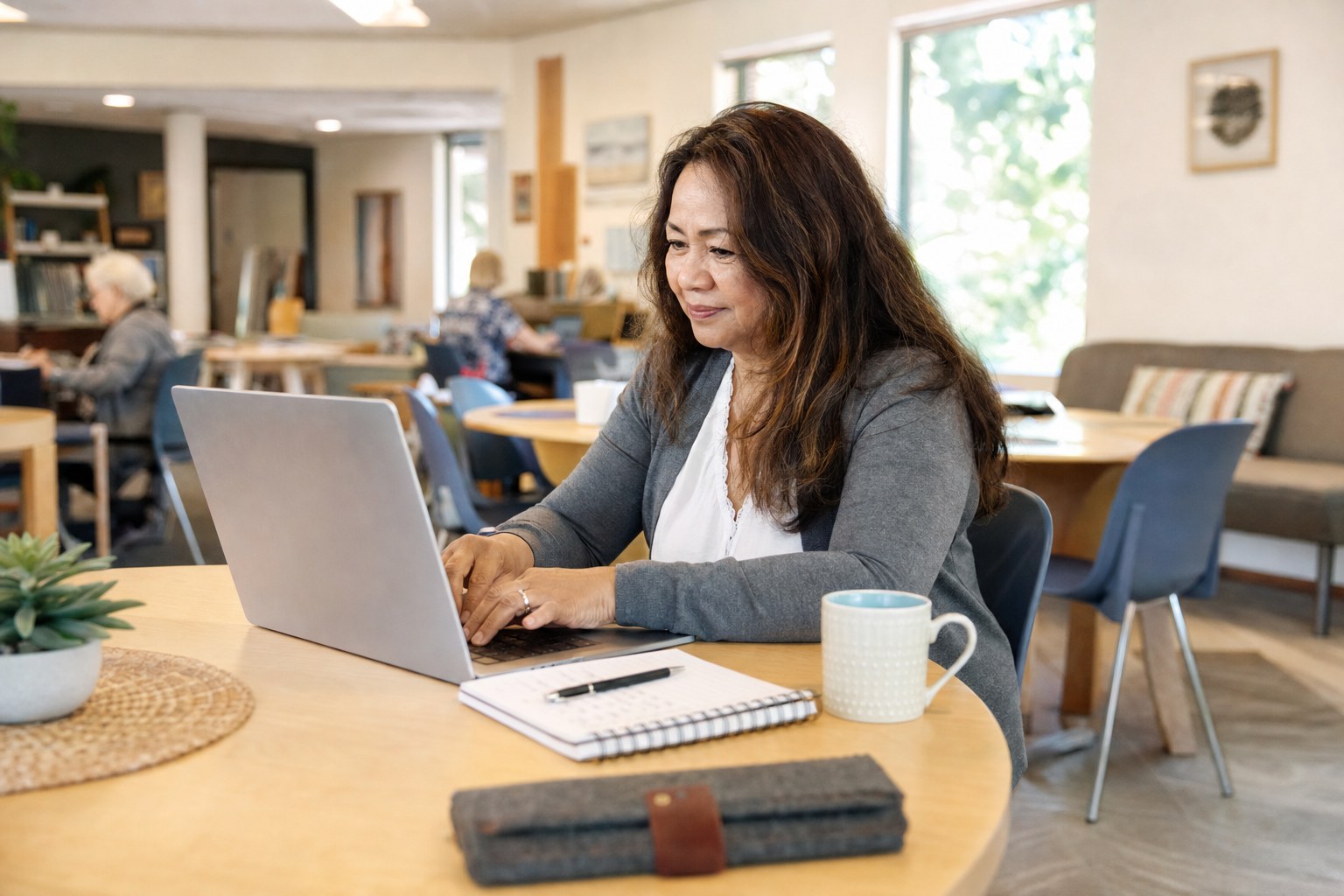 Adult learner practicing computer skills at a community learning table