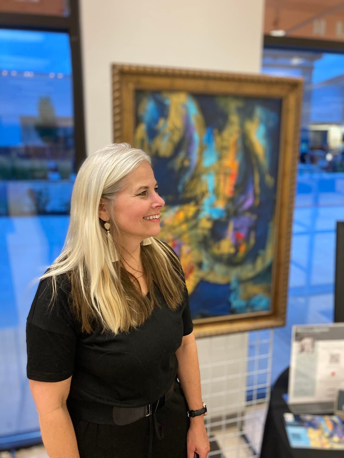 Rebecca Hutchins beside one of her paintings