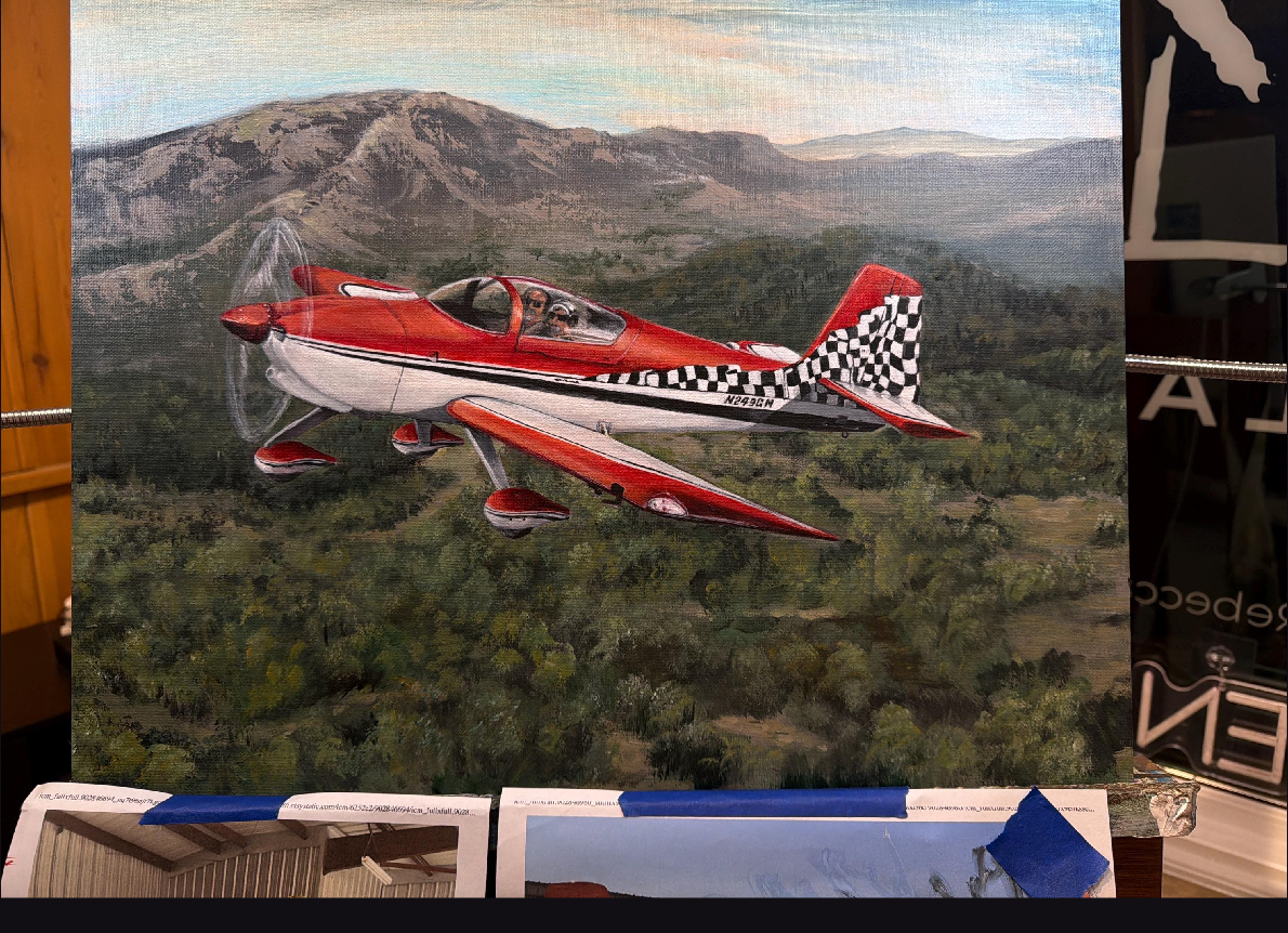 A finished red airplane painting viewed on a phone