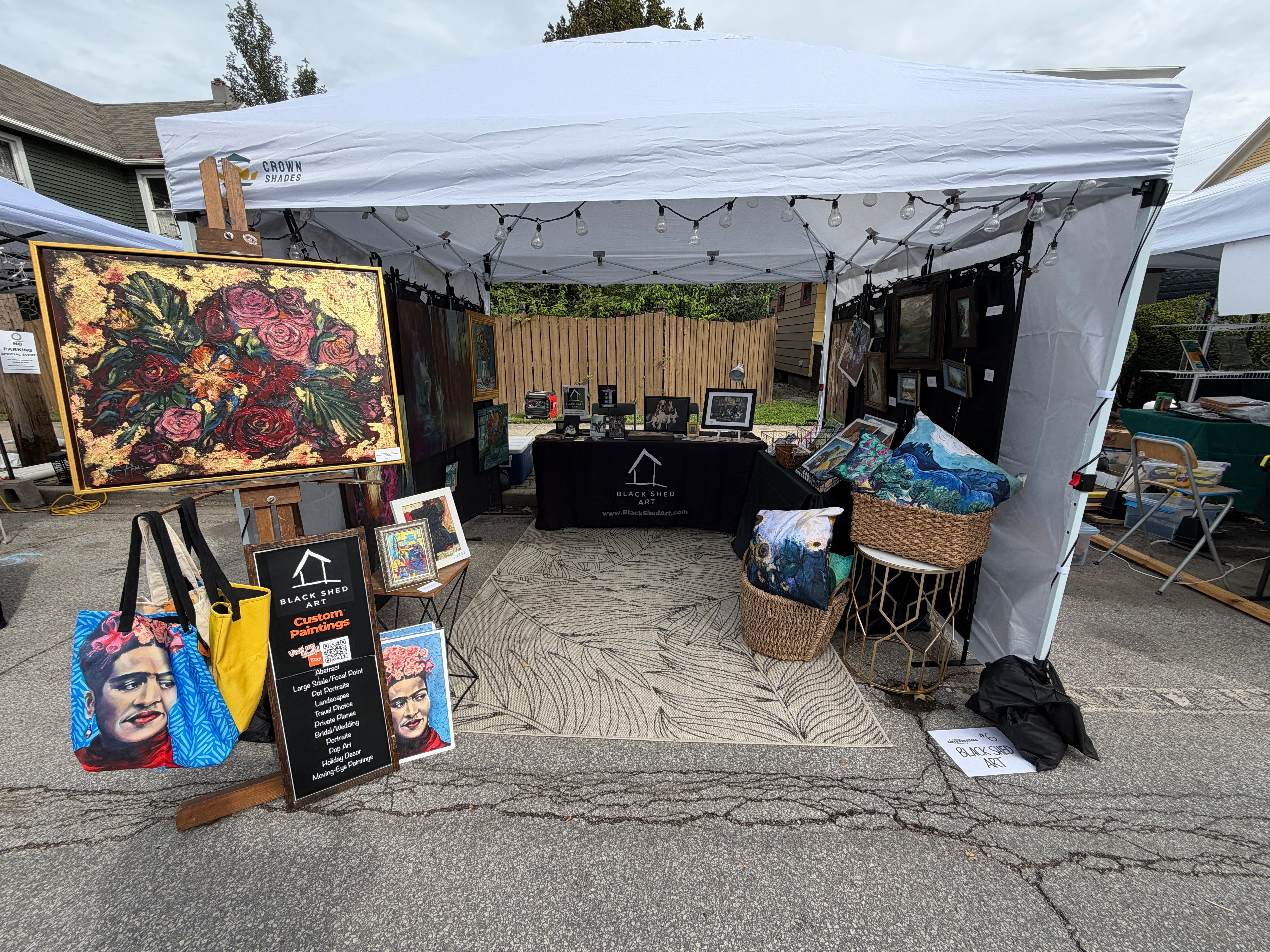 Black Shed Art booth filled with original paintings and artful goods