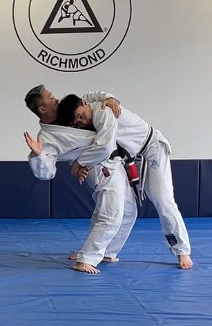 Adults practicing a standing Jiu-Jitsu technique at Bushin