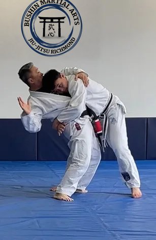 Adults practicing a standing Jiu-Jitsu technique at Bushin