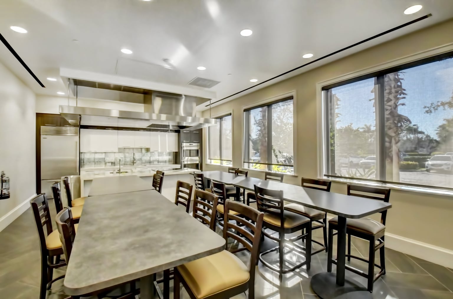 Community dining room with windows and tables in a South Florida active-adult clubhouse