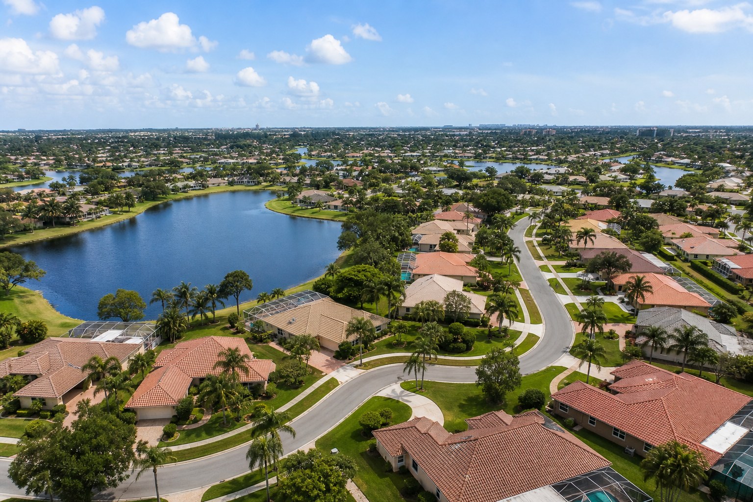 Aerial view of a Palm Beach County active-adult neighborhood with lakes and palm trees