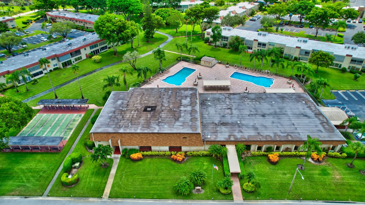 Aerial view of villas, green space, and lakes in a South Florida active-adult community