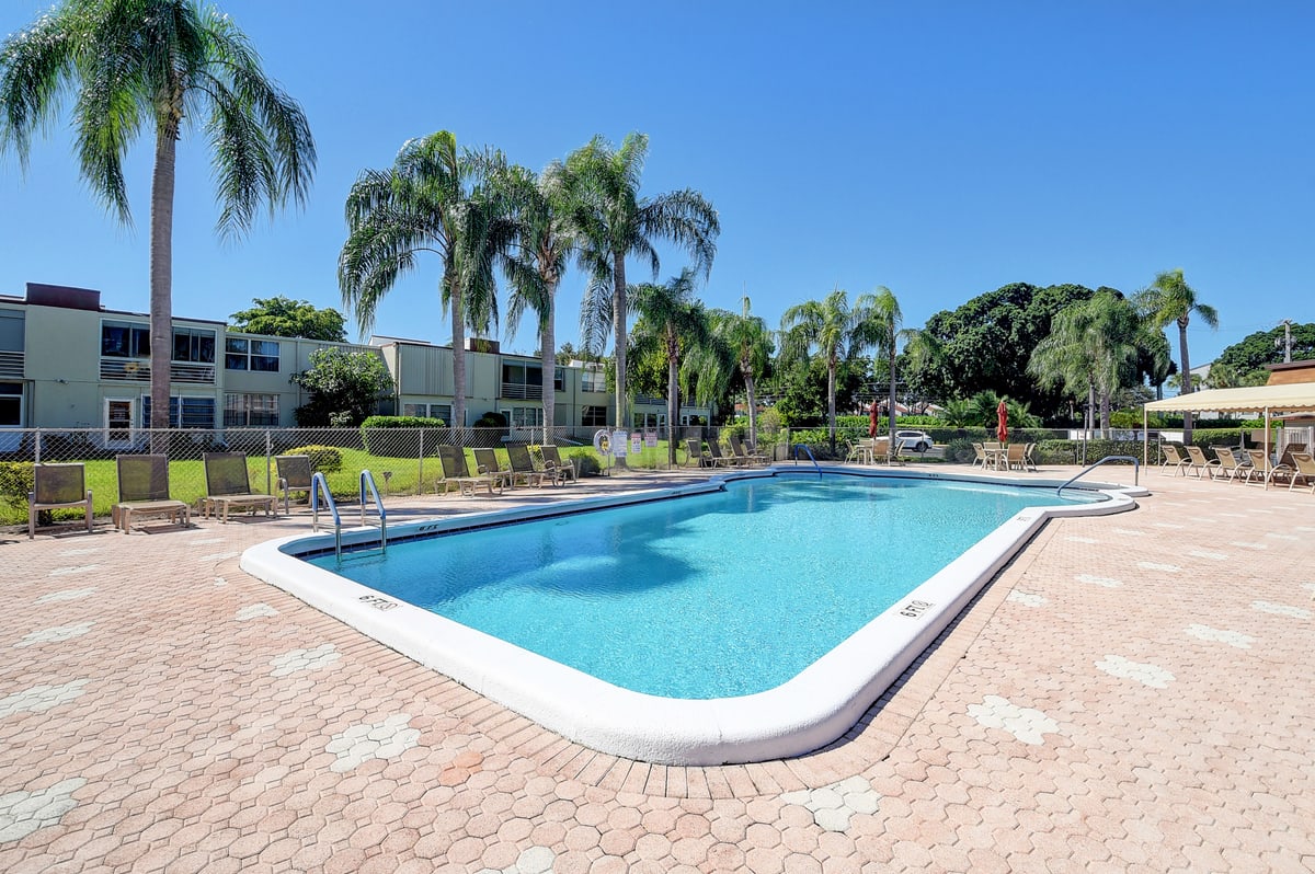 One of the Abbey Village swimming pools with palm trees