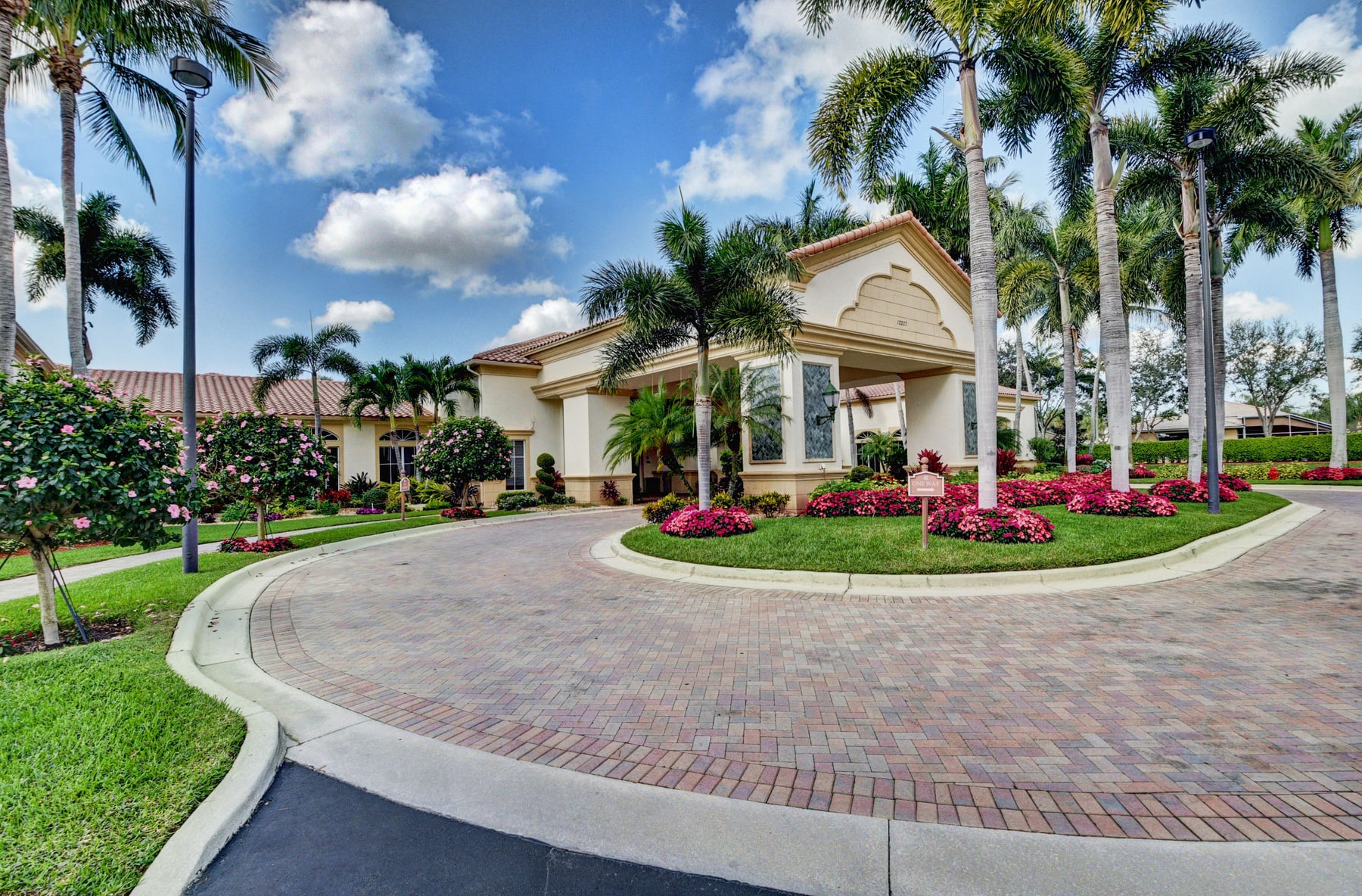 Palm-lined clubhouse arrival at Avalon Estates