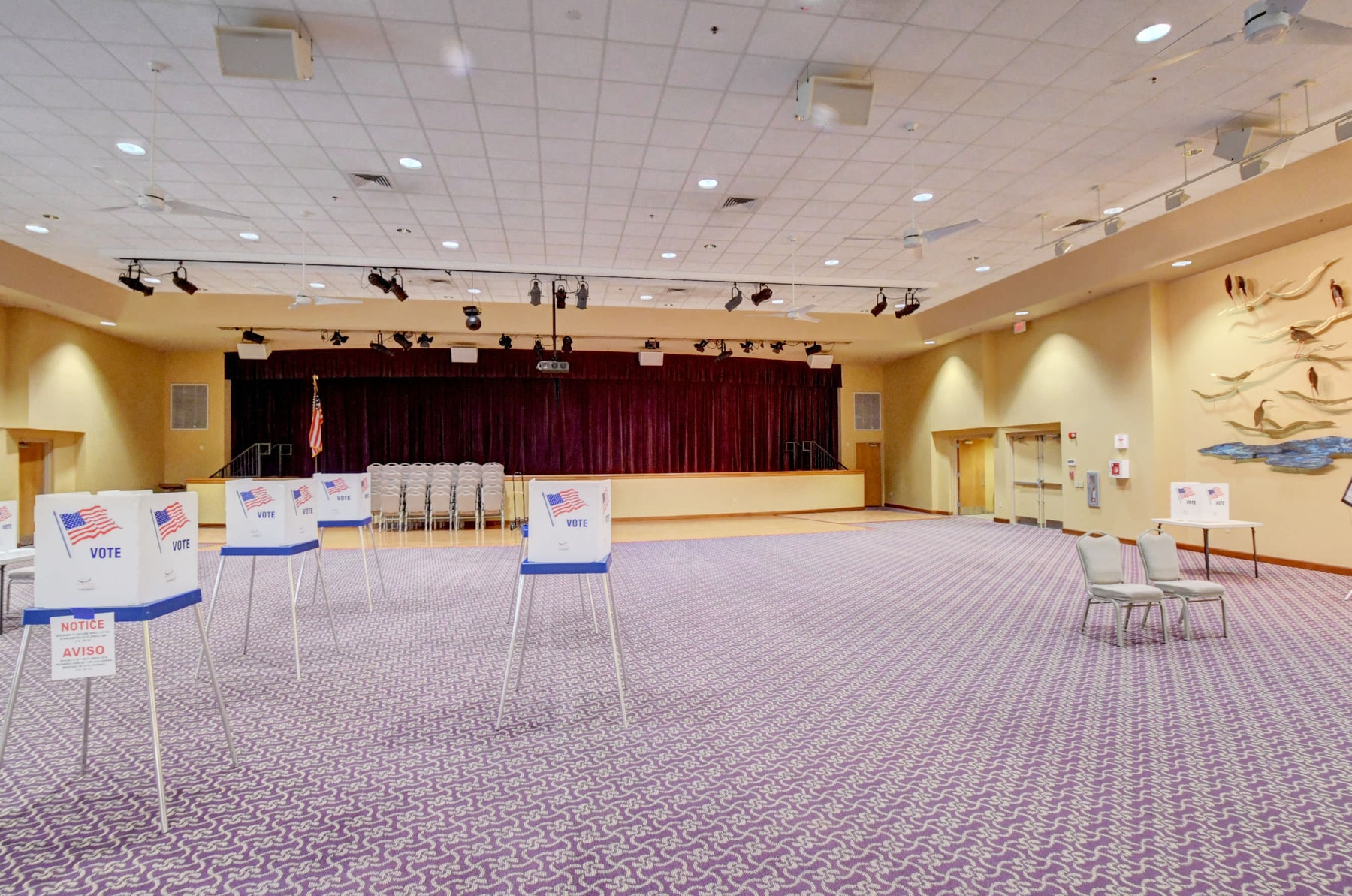 Social hall with stage and event seating at Banyan Springs