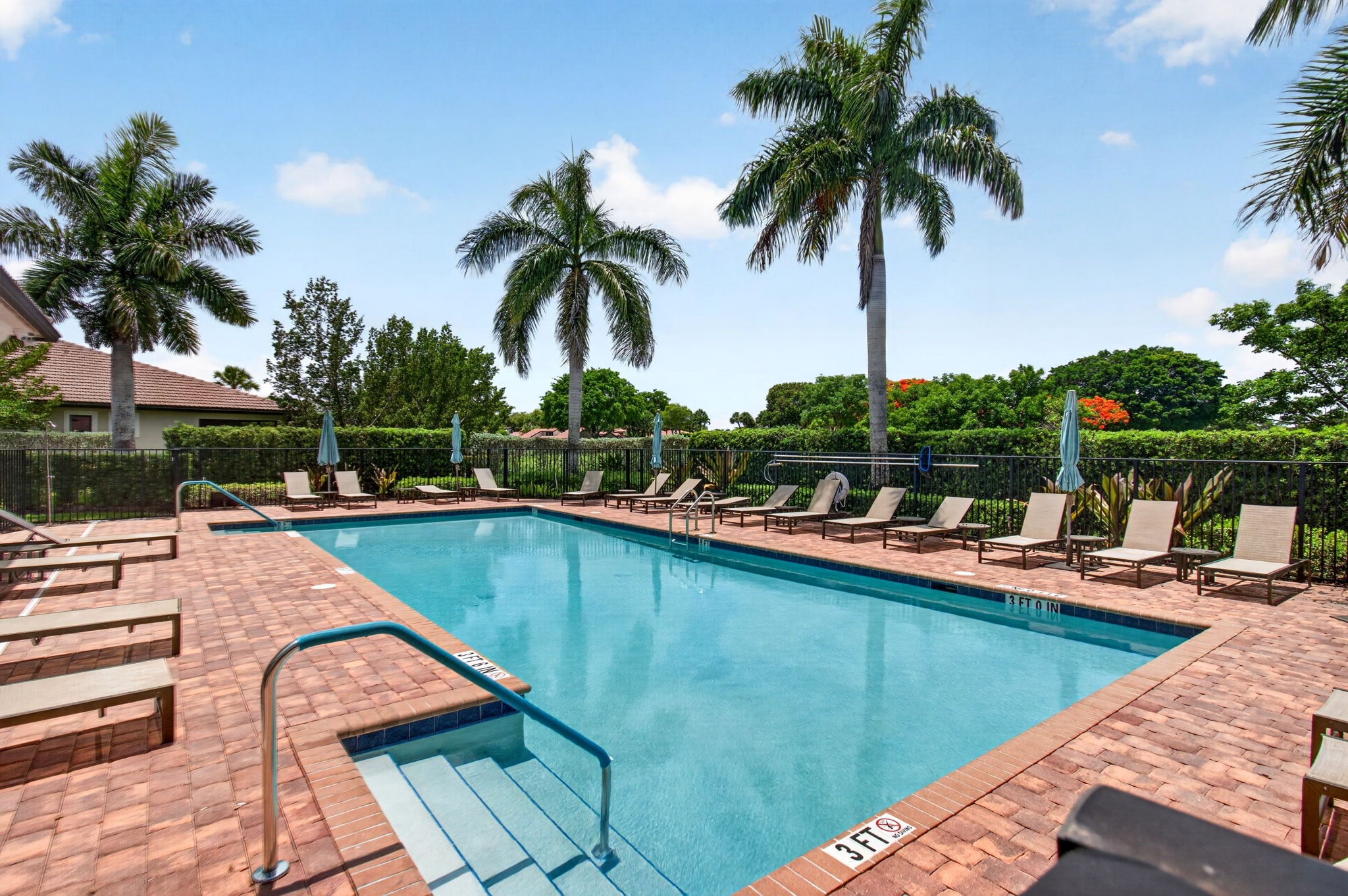Boca Flores community pool with surrounding lounge chairs