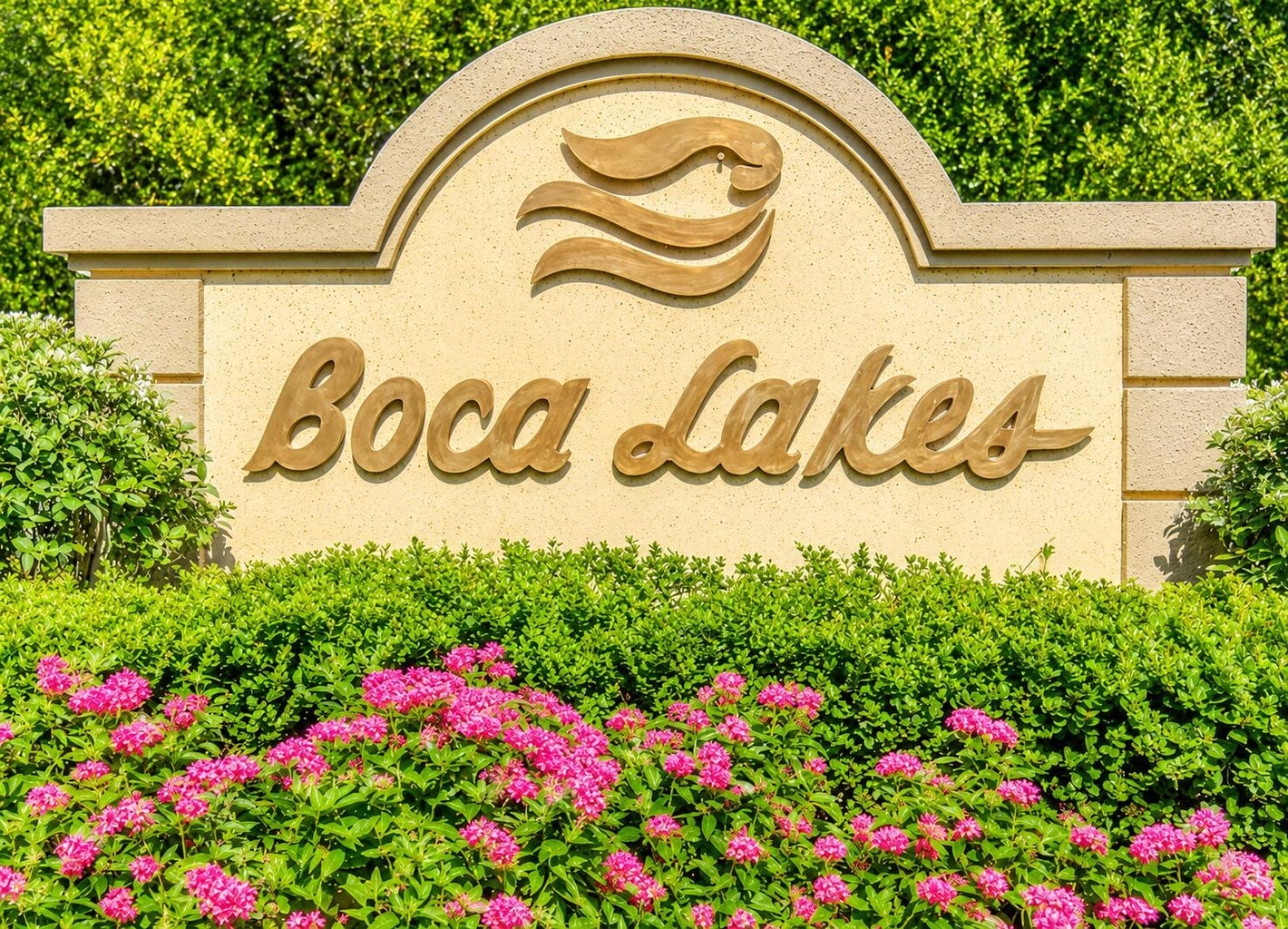 Boca Lakes community entrance sign surrounded by tropical landscaping