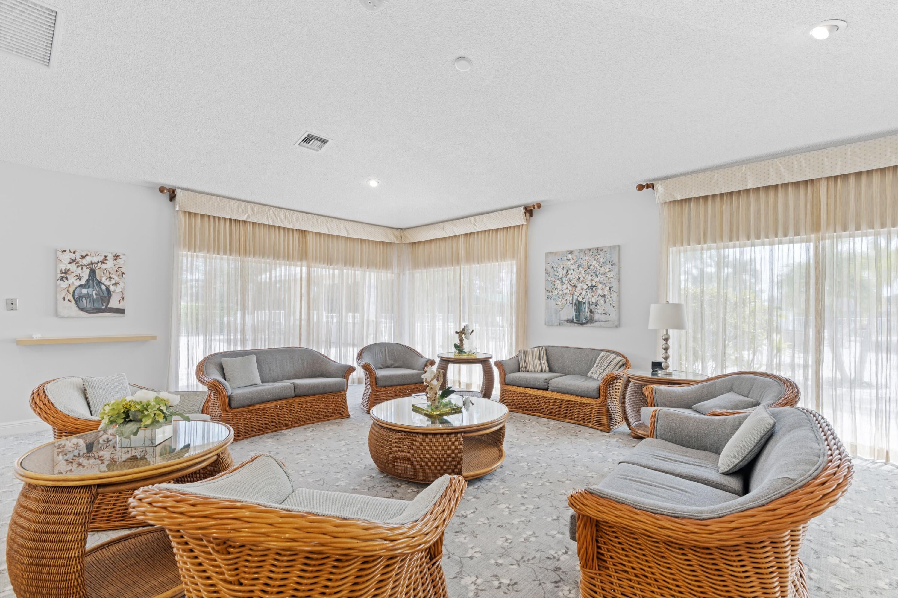 Boca Lakes clubhouse lounge with wicker seating