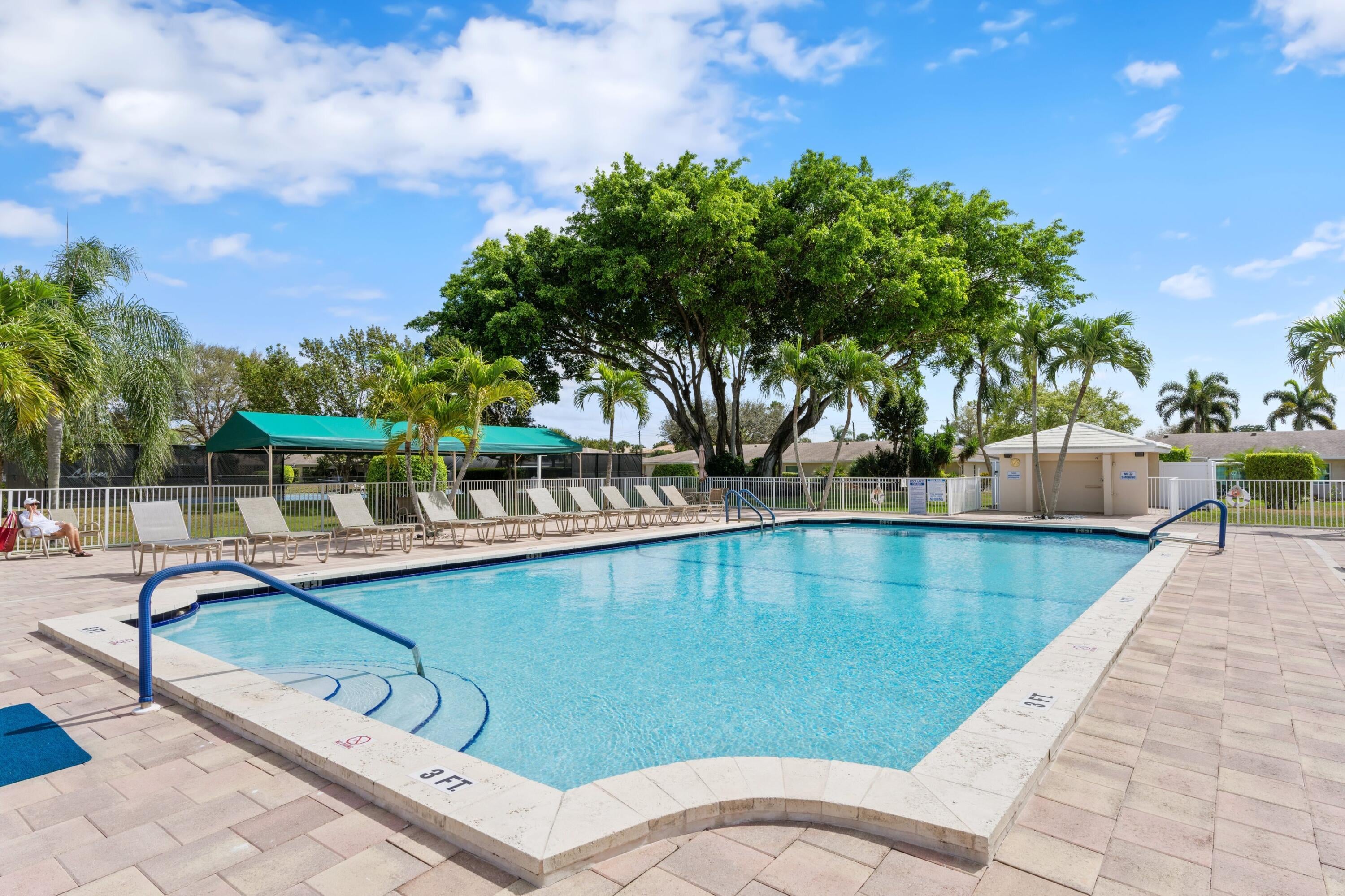 Boca Lakes community swimming pool and lounge area