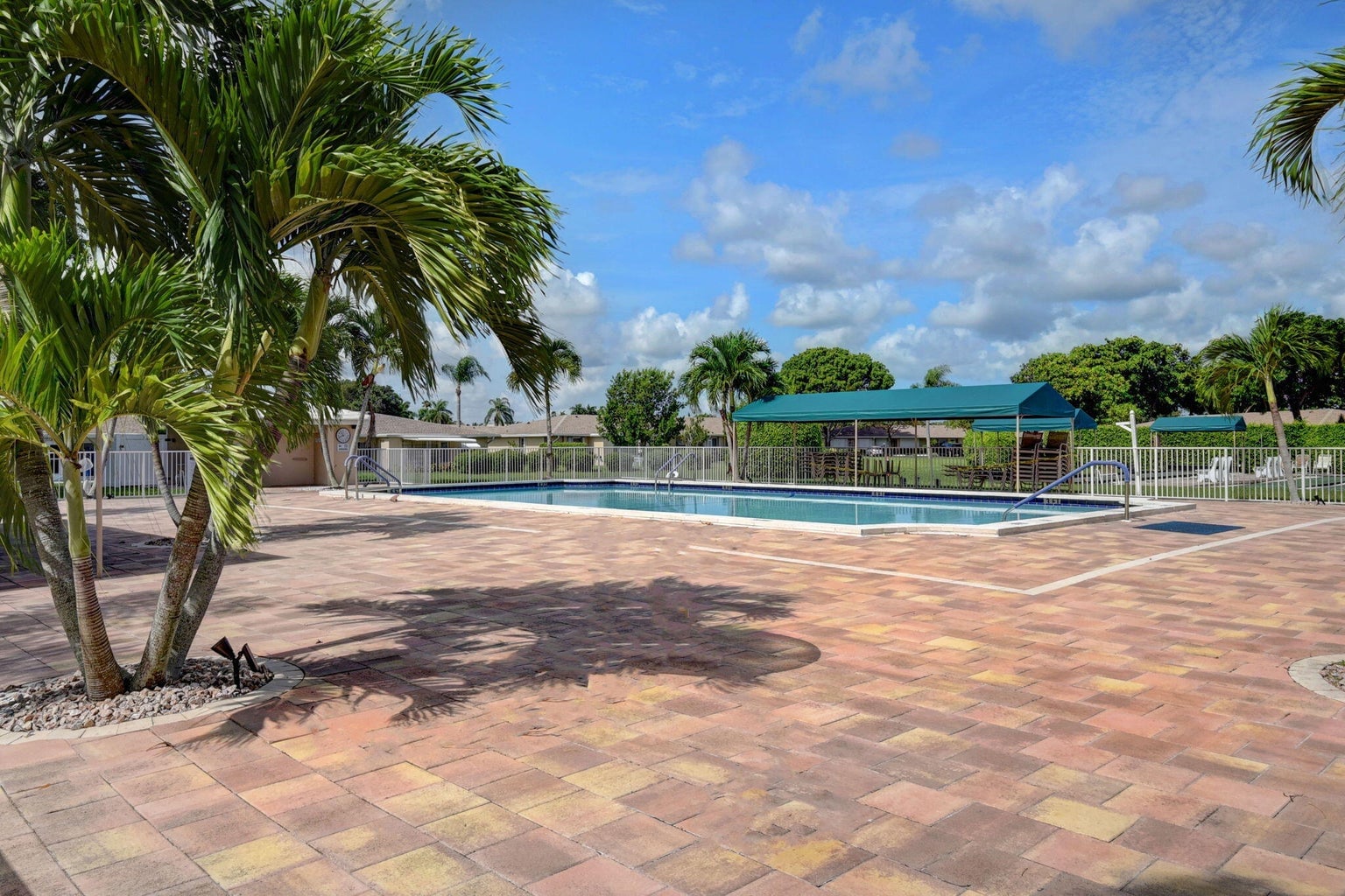 Boca Lakes pool deck framed by palm trees