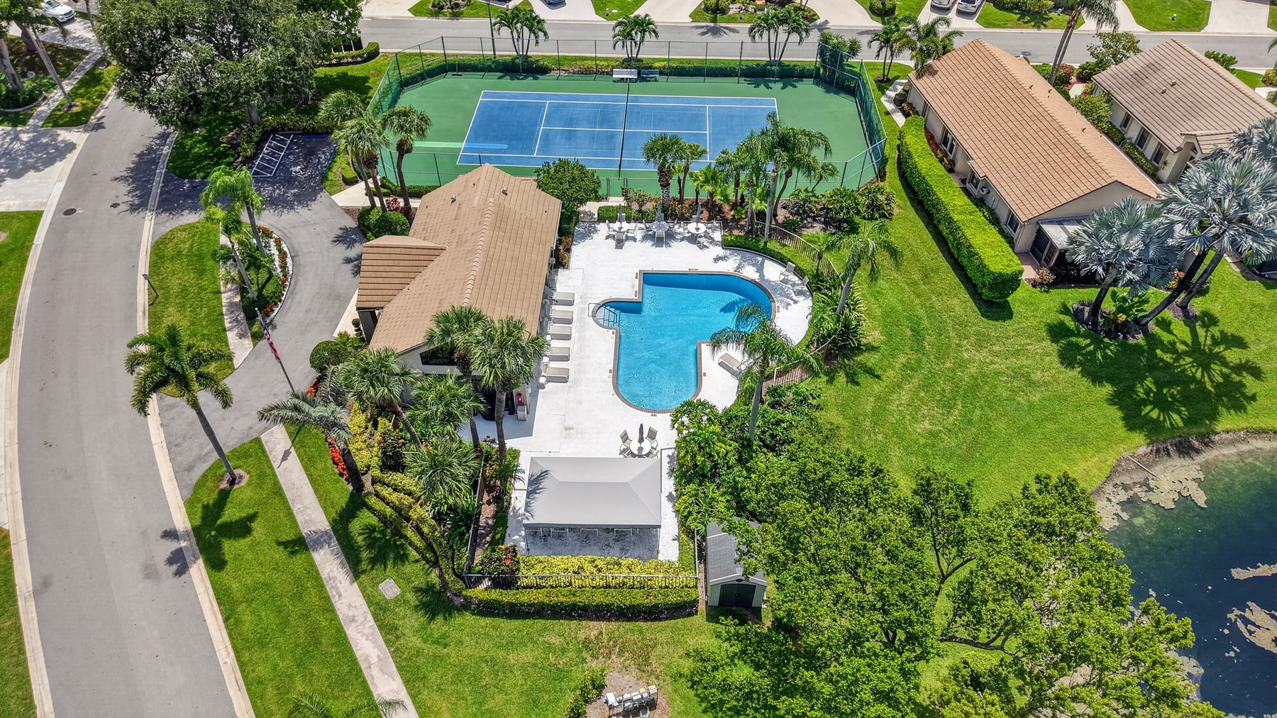 Aerial view of the Brighton Lakes clubhouse, pool, and tennis court