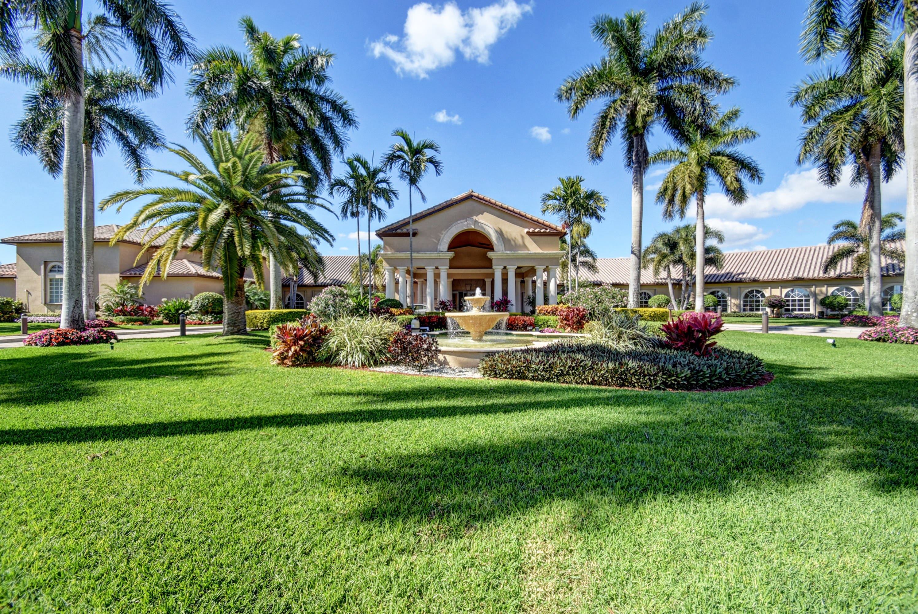 Palm-lined arrival at The Cascades clubhouse in Boynton Beach