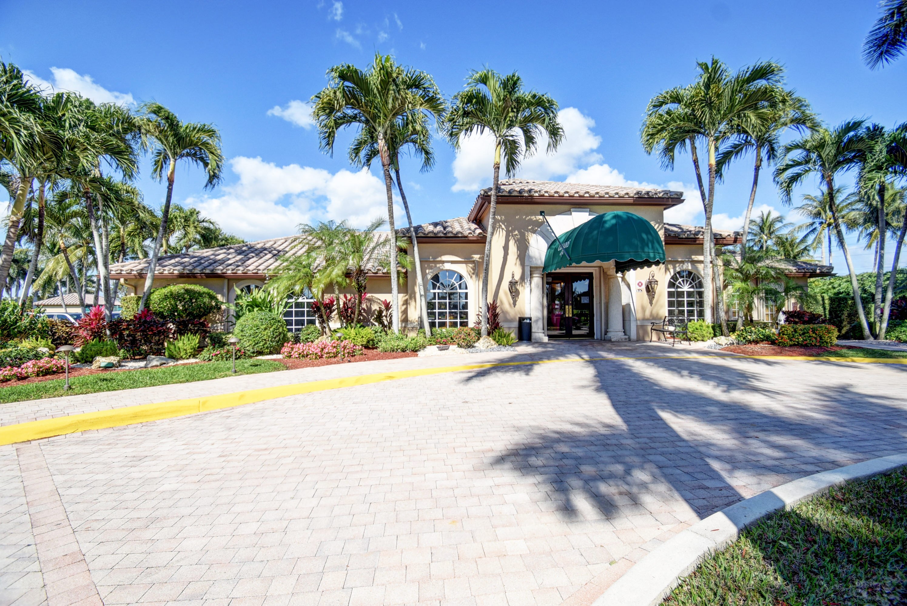 Palm-lined entrance to The Cascades active-adult community in Boynton Beach