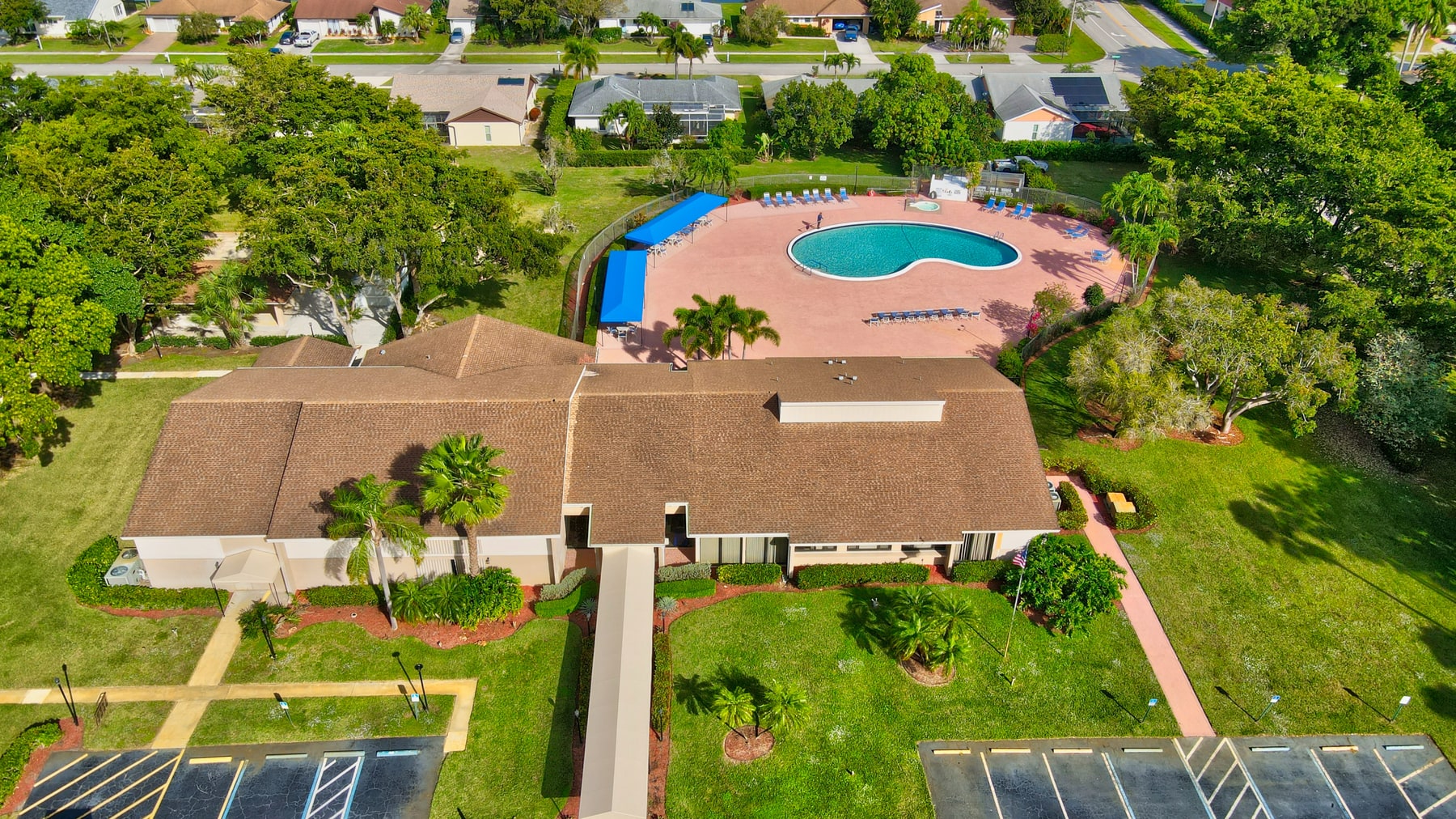 Aerial view of Coco Wood Lakes pool and clubhouse amenities