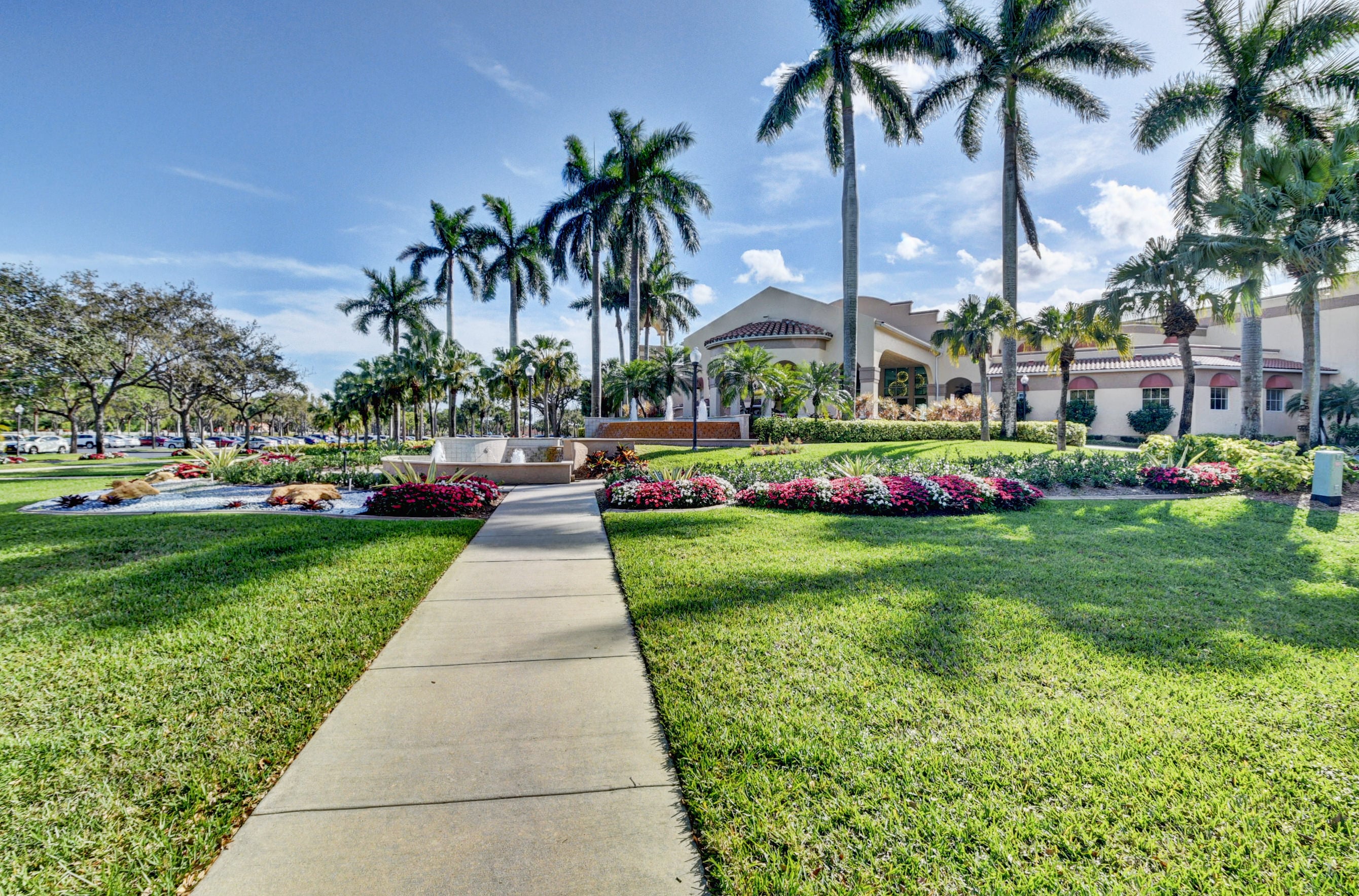 Palm-lined arrival at the Coral Lakes clubhouse