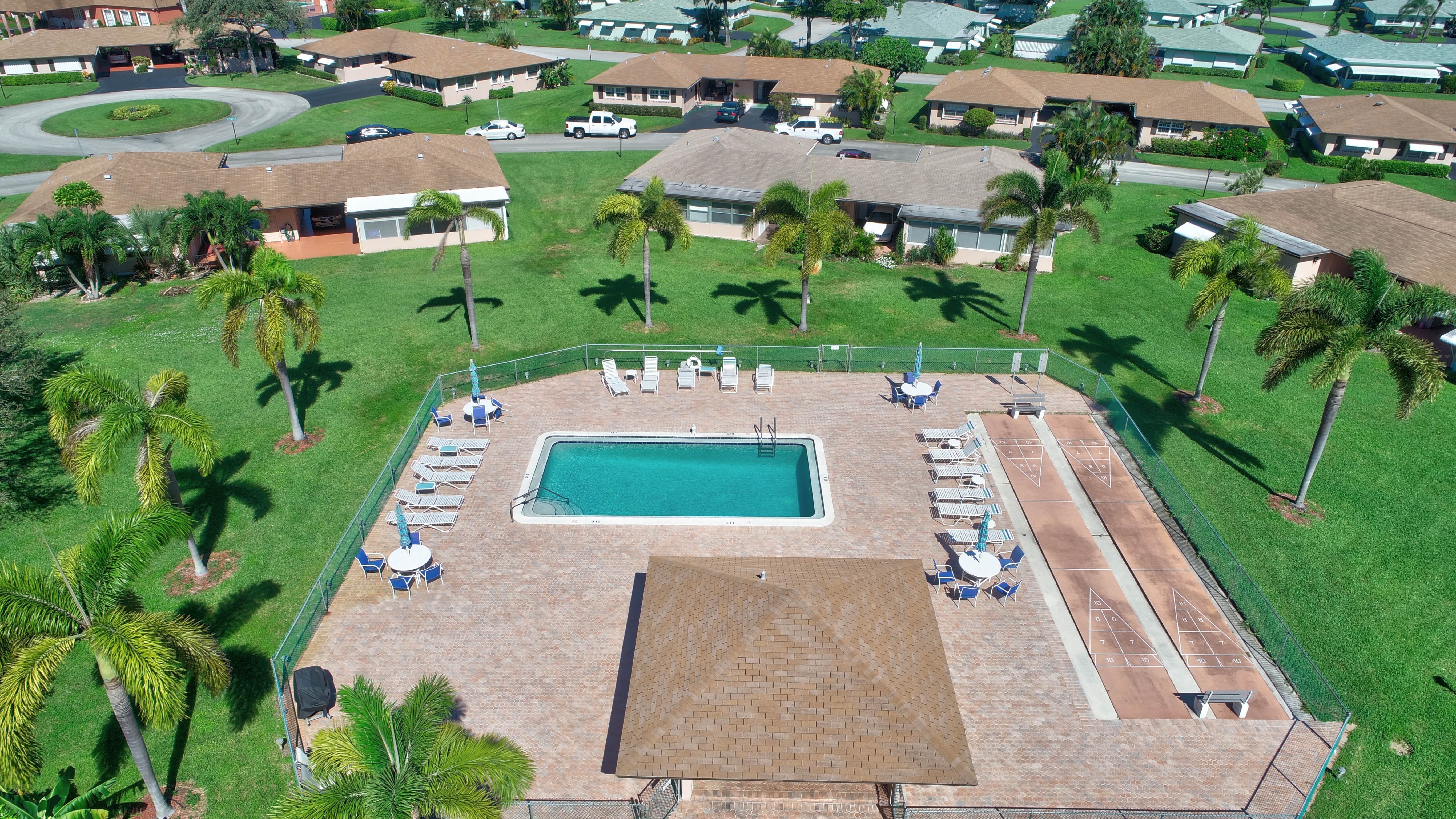 Aerial view of villas, lakes, and landscaped streets in a South Florida active-adult community