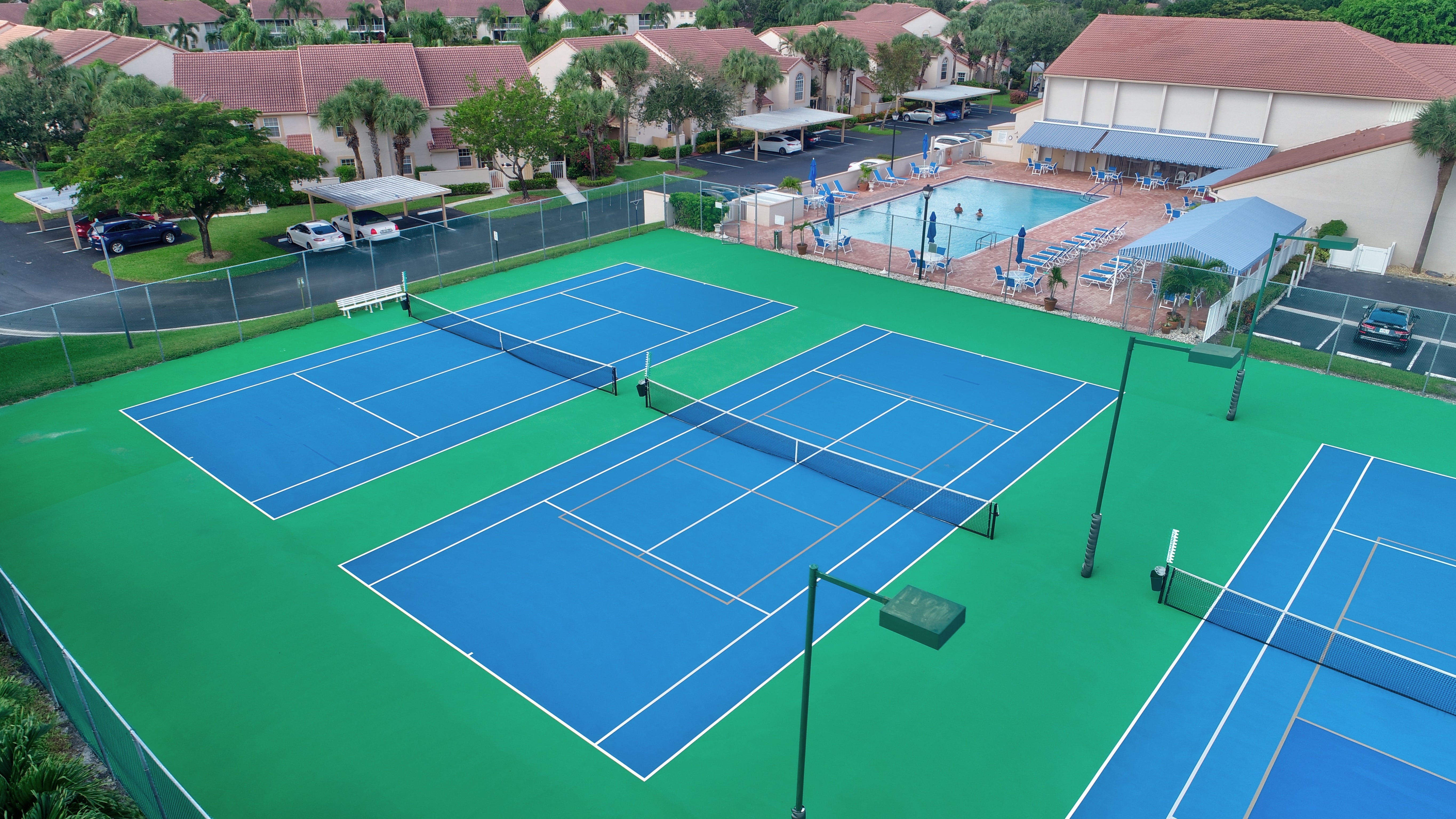 Aerial view of Emerald Pointe clubhouse, pool, and courts