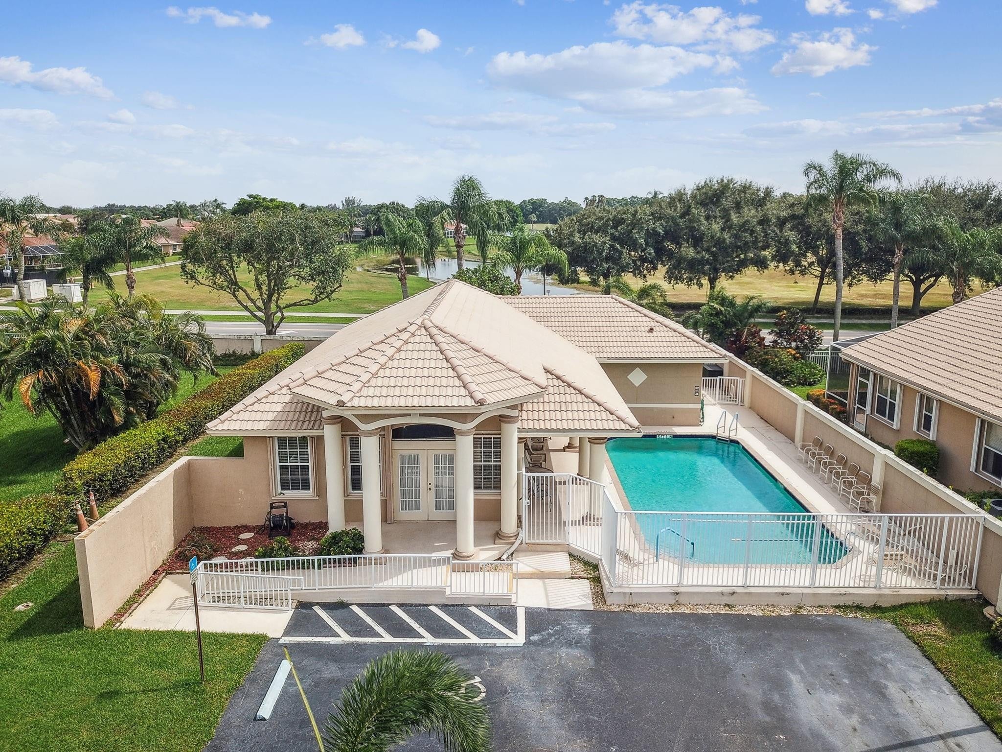 Aerial view of the Enclave at Westchester clubhouse, pool and lake in Boynton Beach