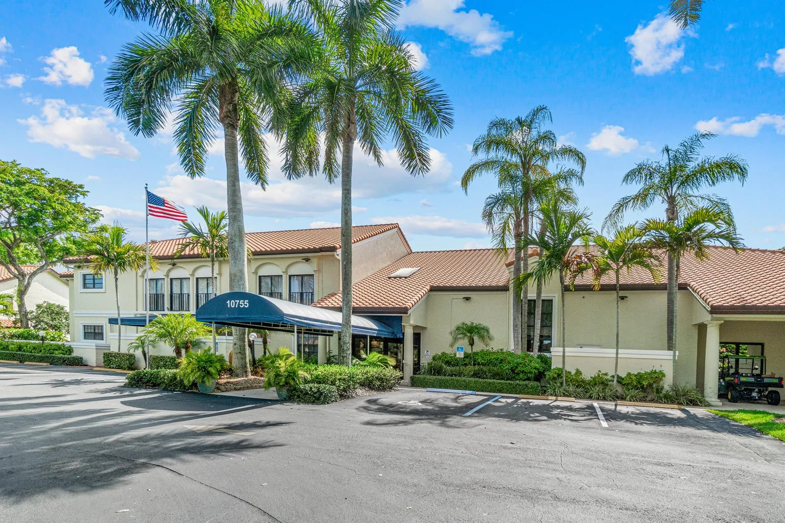 South Florida active-adult community clubhouse surrounded by palm trees