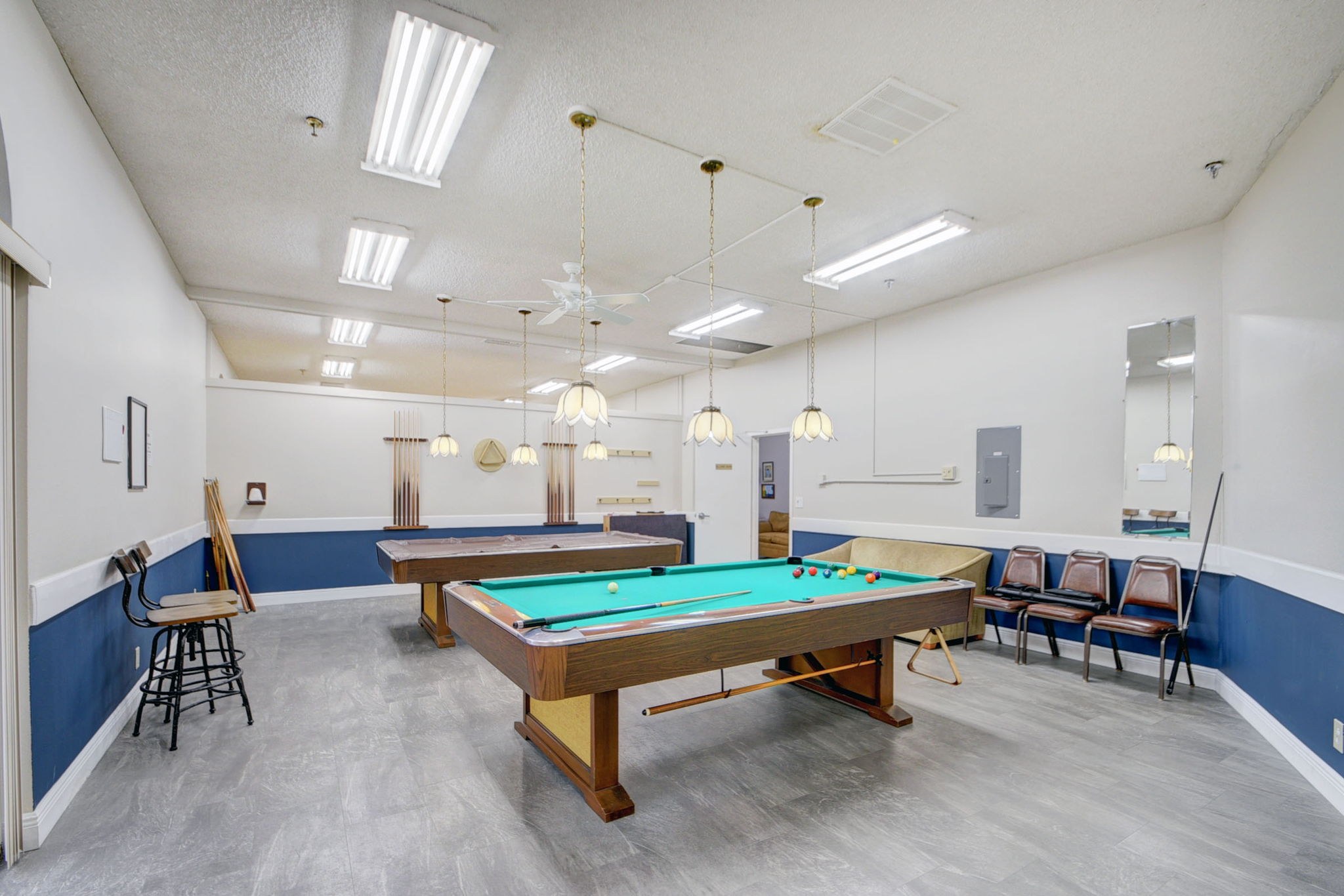 Poinciana billiards room with pool tables and recreation seating