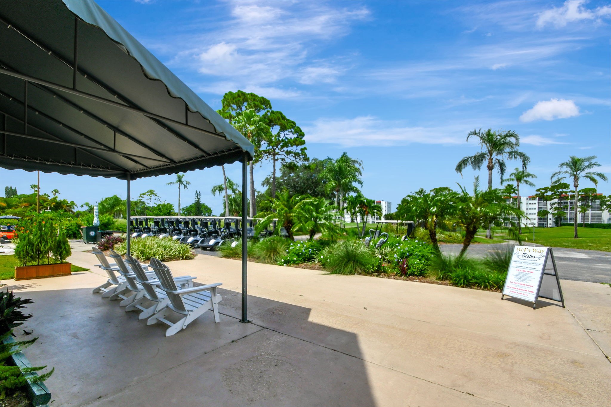 Patio seating and golf carts overlooking the Poinciana golf course
