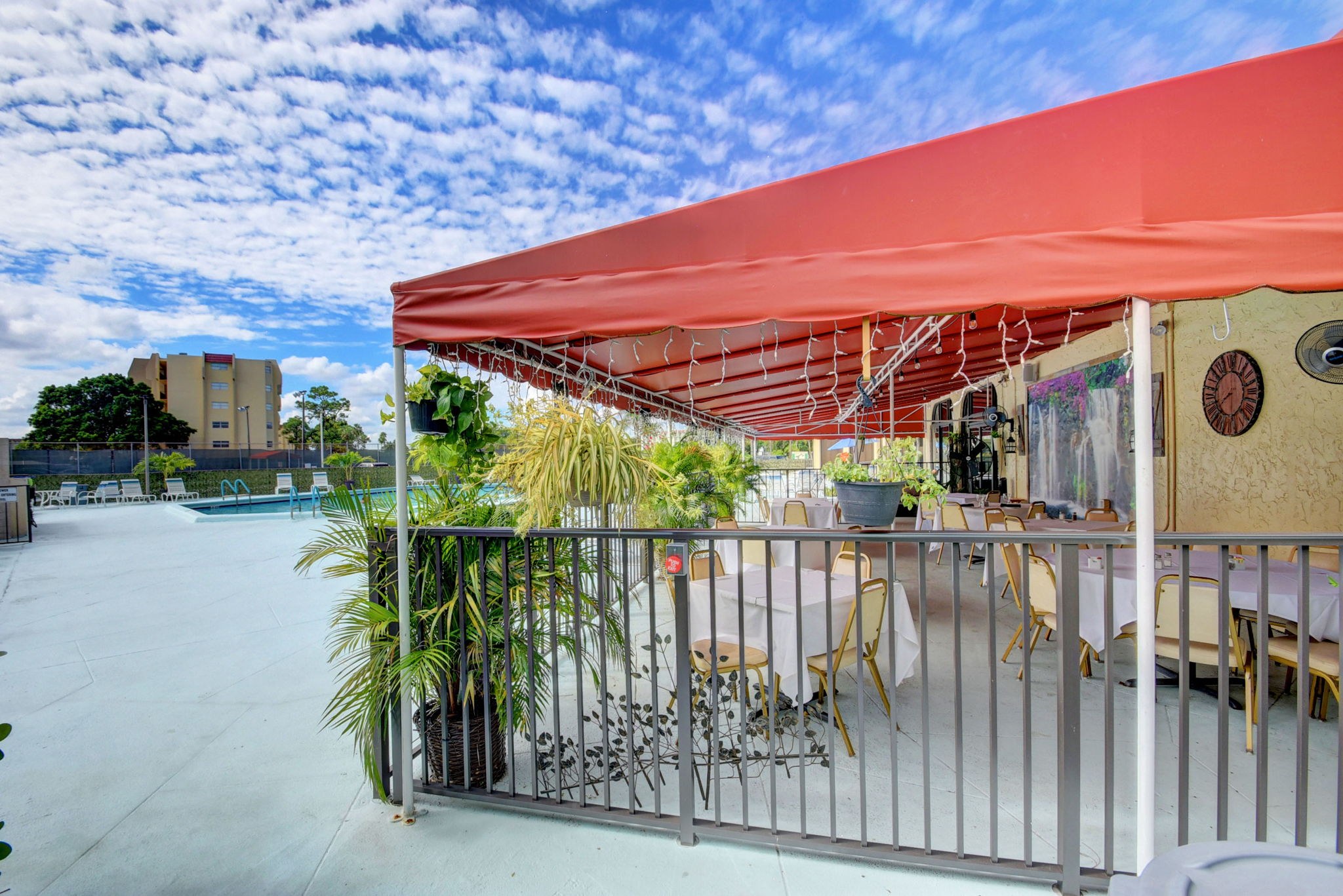 Outdoor poolside bistro seating at Poinciana in Lake Worth