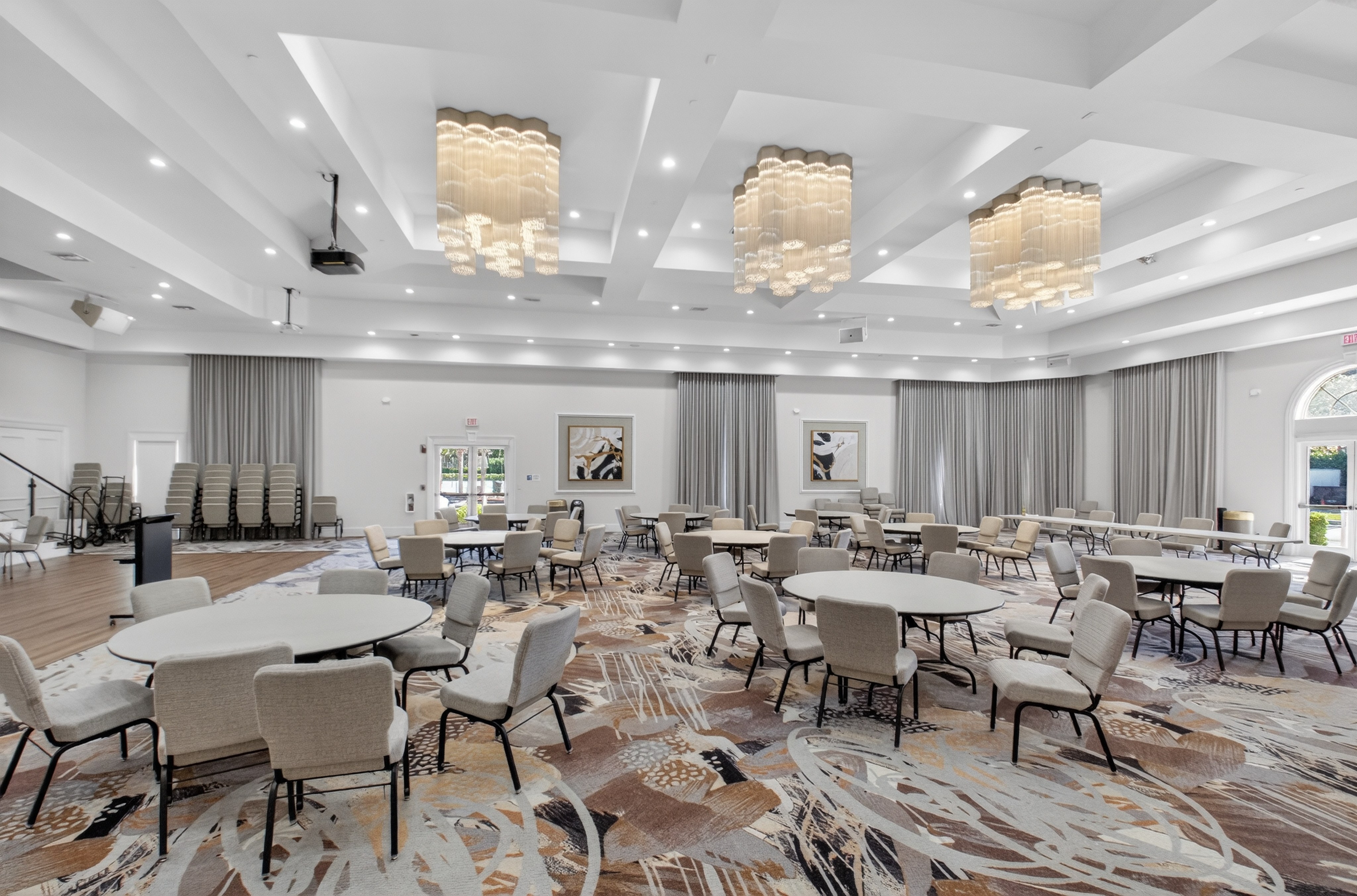 Ponte Vecchio clubhouse ballroom with seating and chandeliers