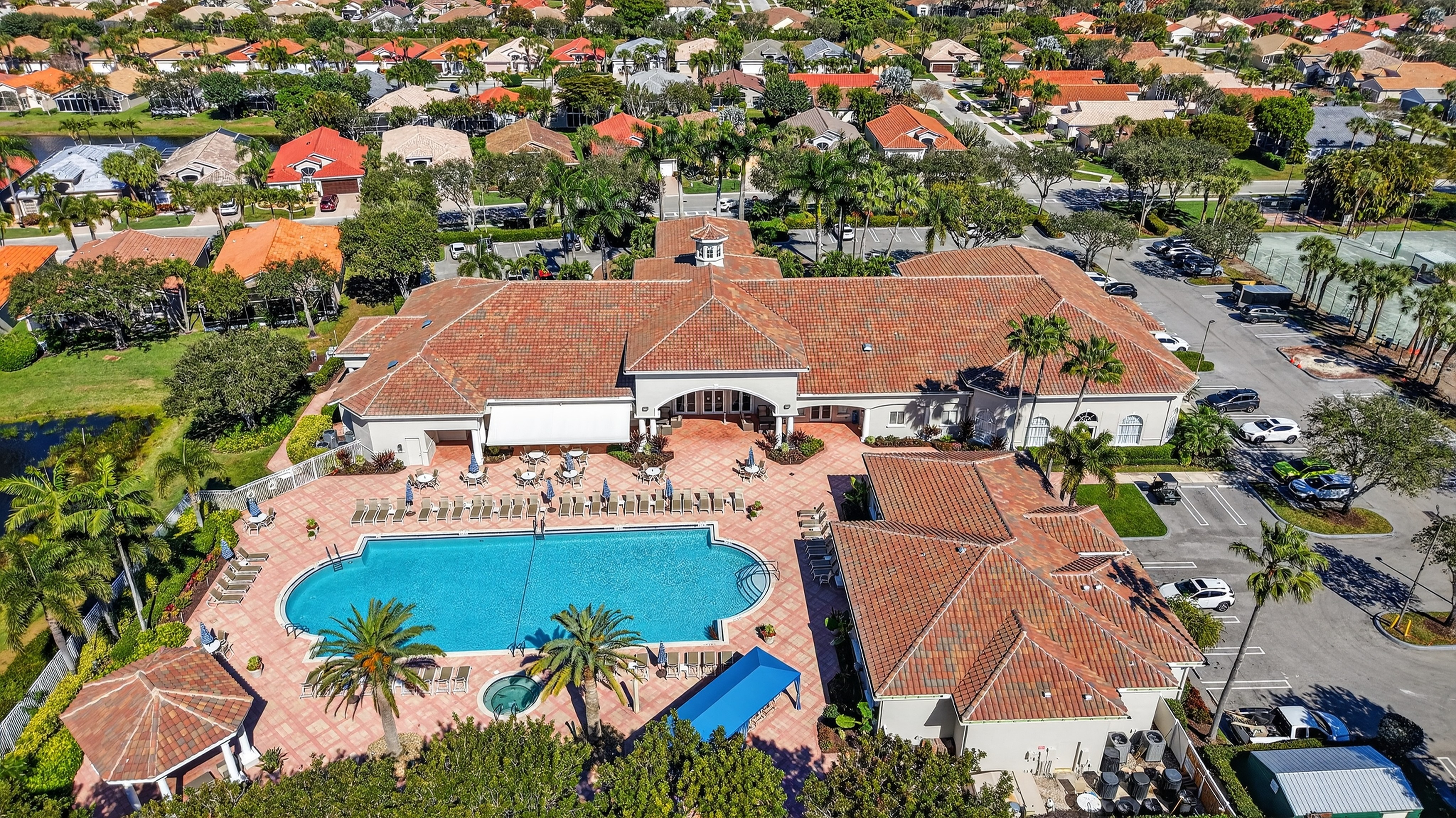 Aerial view of the Ponte Vecchio clubhouse, pool, and surrounding single-family homes in Boynton Beach