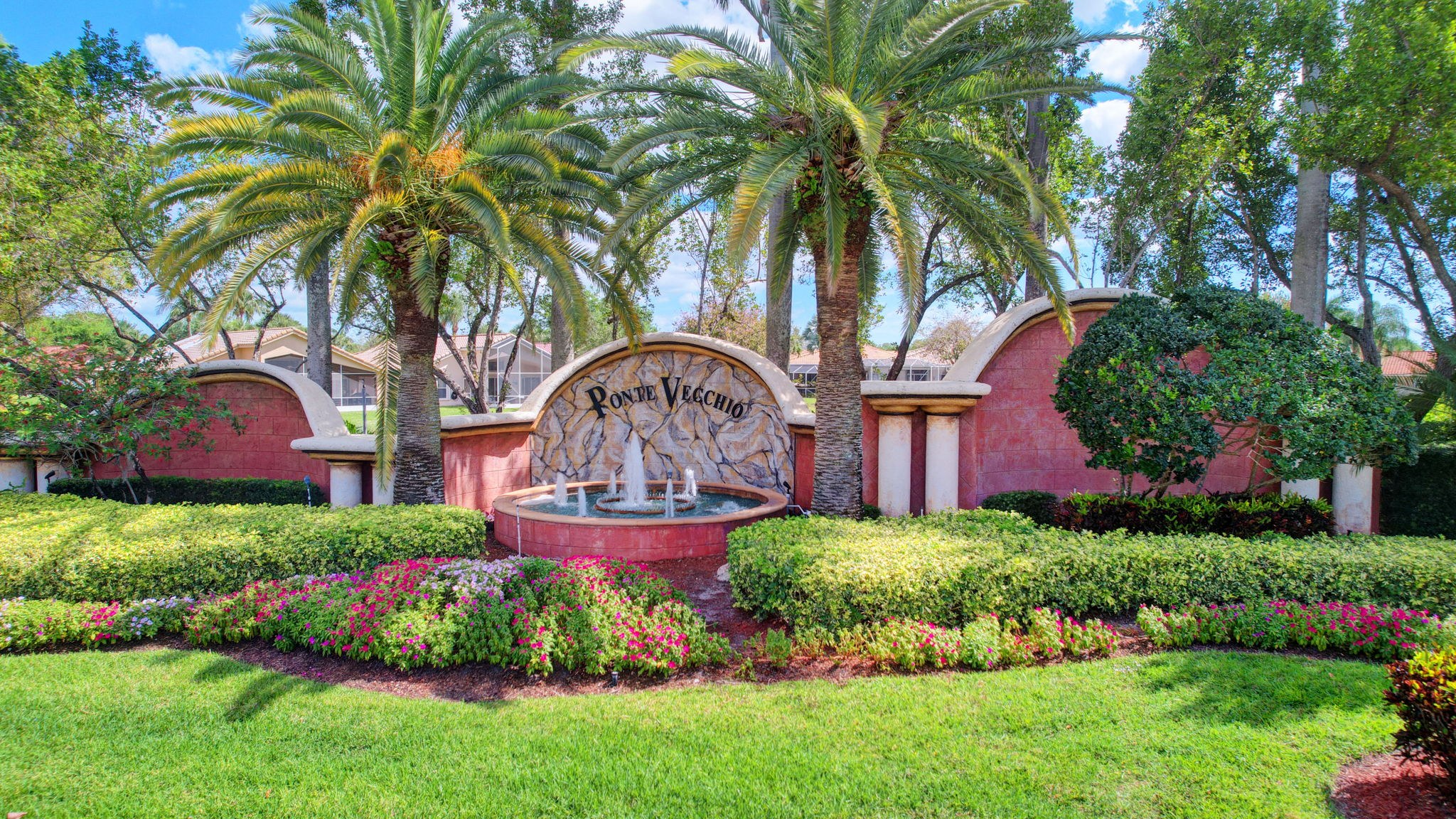 Ponte Vecchio entrance sign with palms, fountain, and landscaped gardens in Boynton Beach