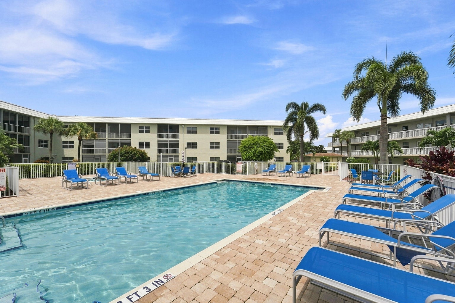 Sandalfoot South community swimming pool with lounge chairs