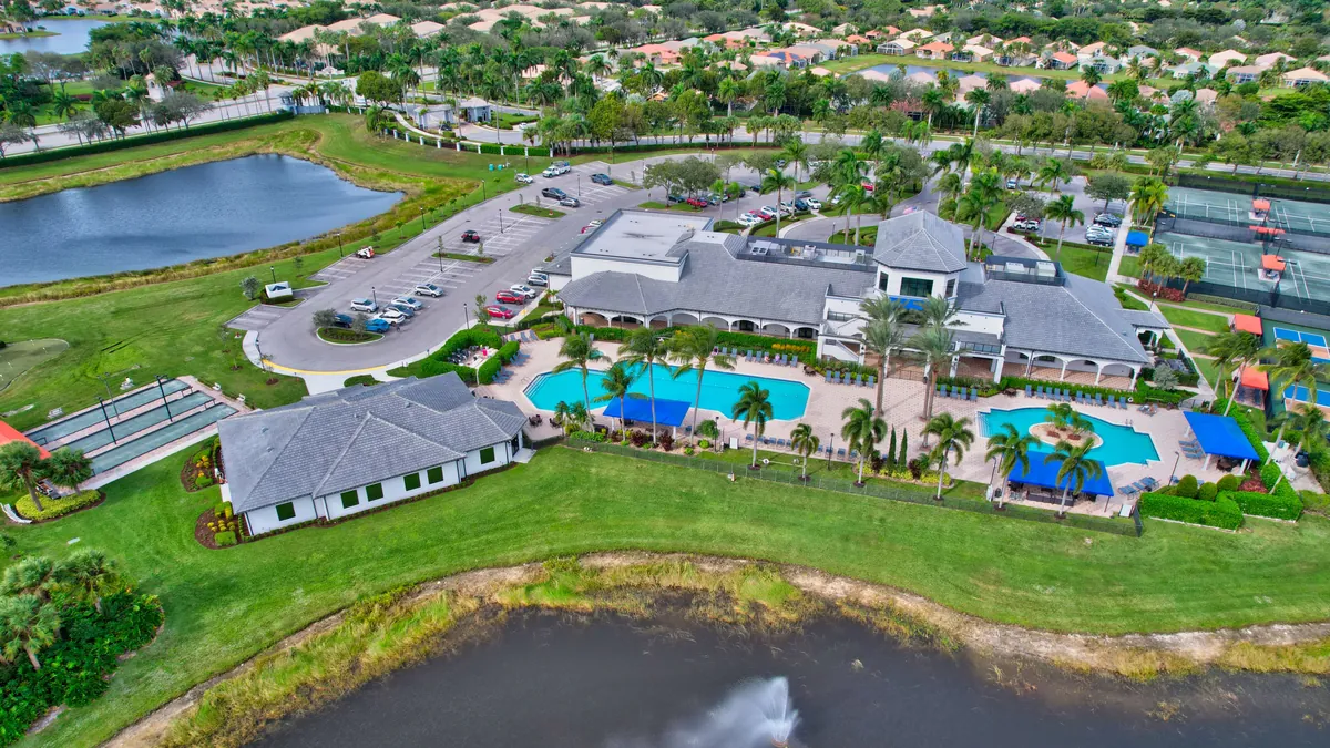 Aerial view of a South Florida active-adult clubhouse, pool, and homes