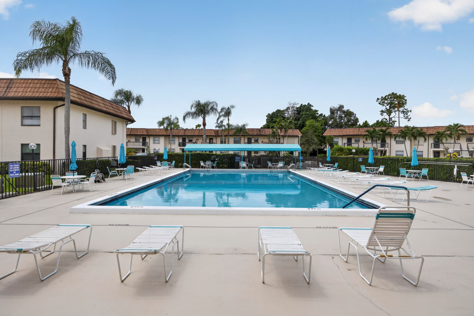 Resort-style outdoor pool with loungers at Lucerne Lakes