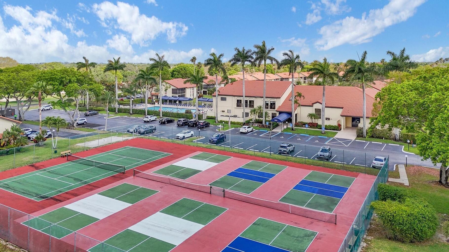 Aerial view of the Palm Chase Lakes tennis and pickleball court complex beside the clubhouse